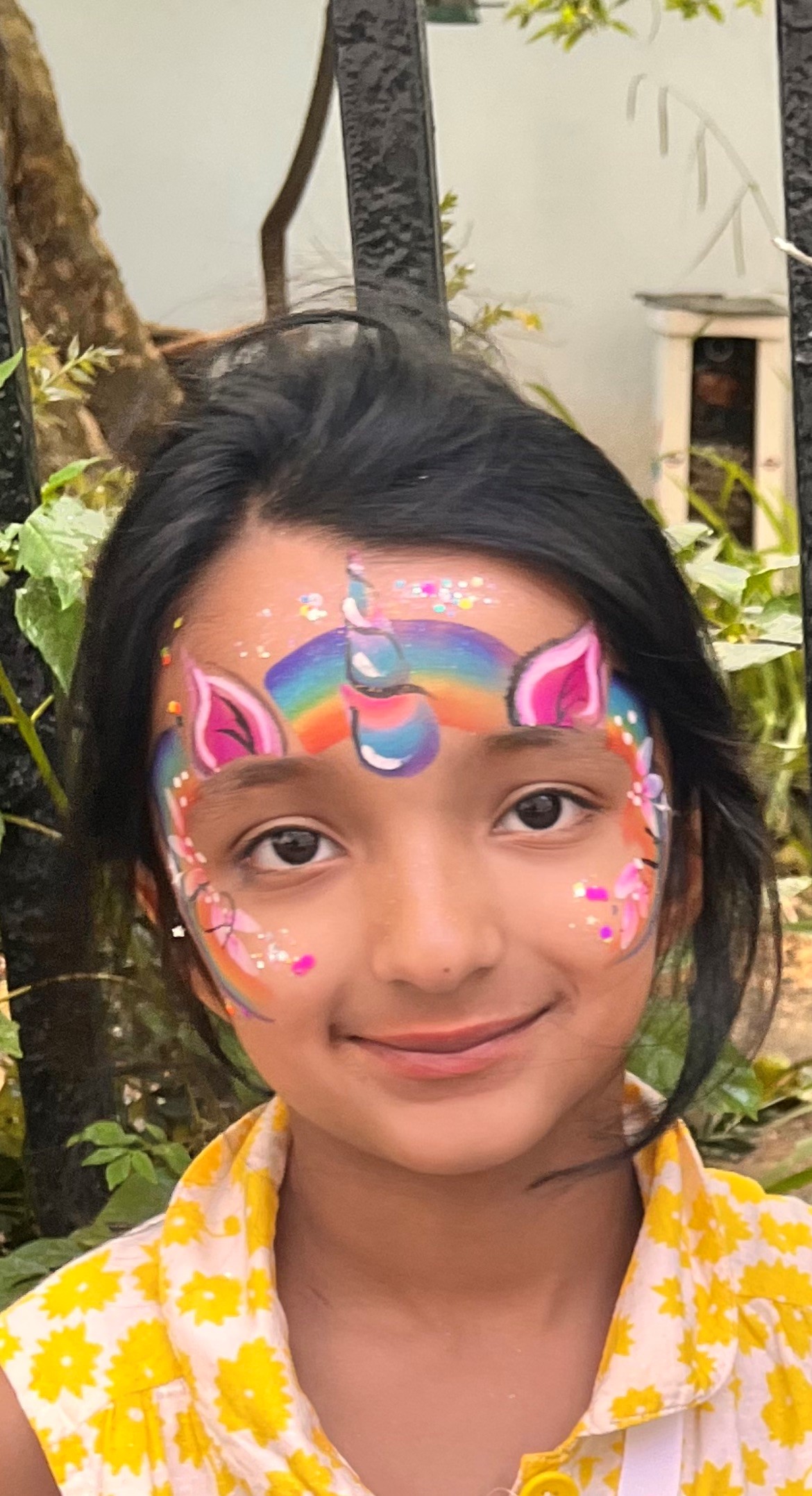 Daya with her face painted as a unicorn
