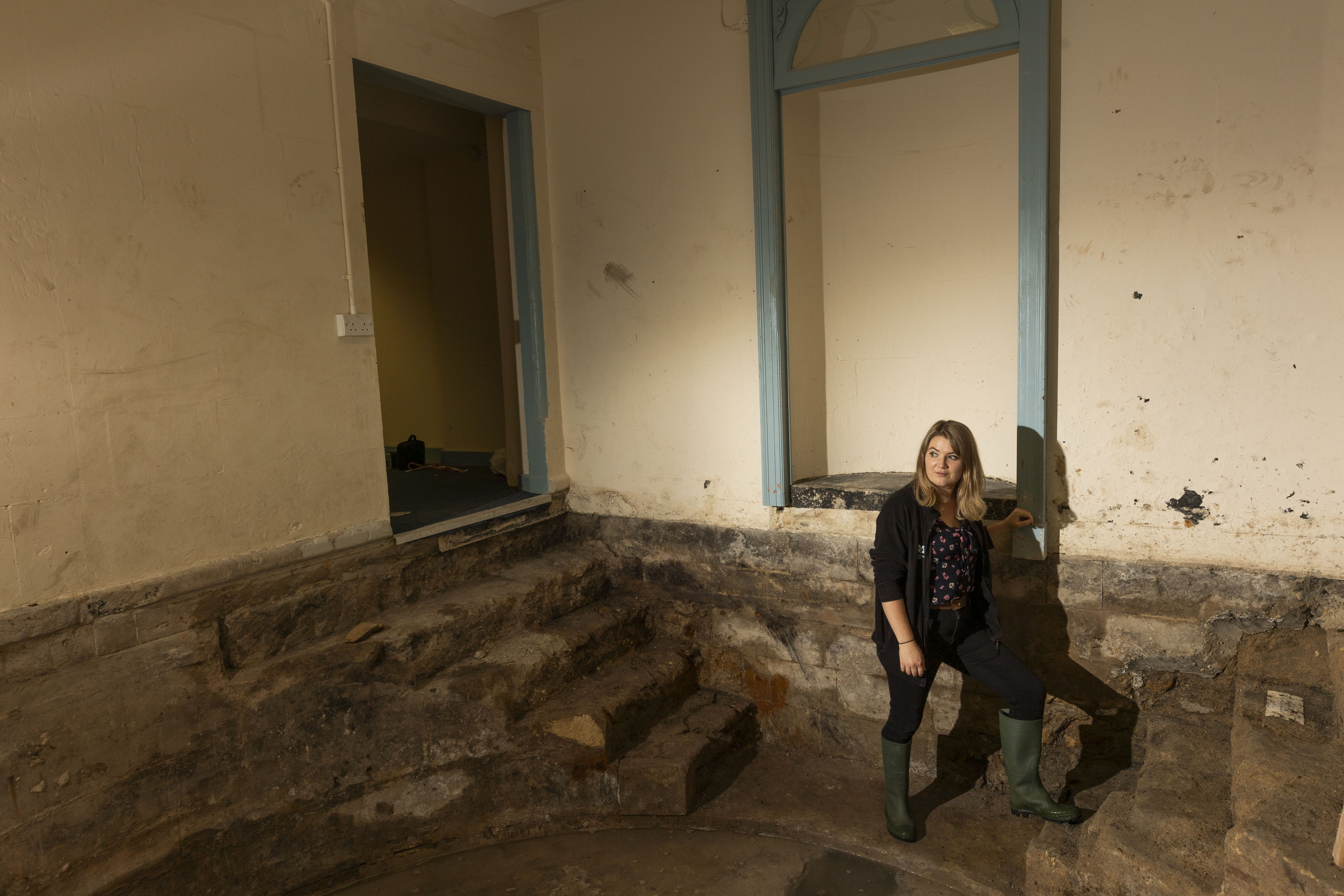 Alana Wright, of the National Trust, in the newly uncovered 18th-century cold bath (James Beck/National Trust/PA)
