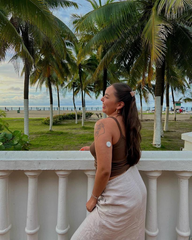 Jasmine Jaffar outside, next to palm trees