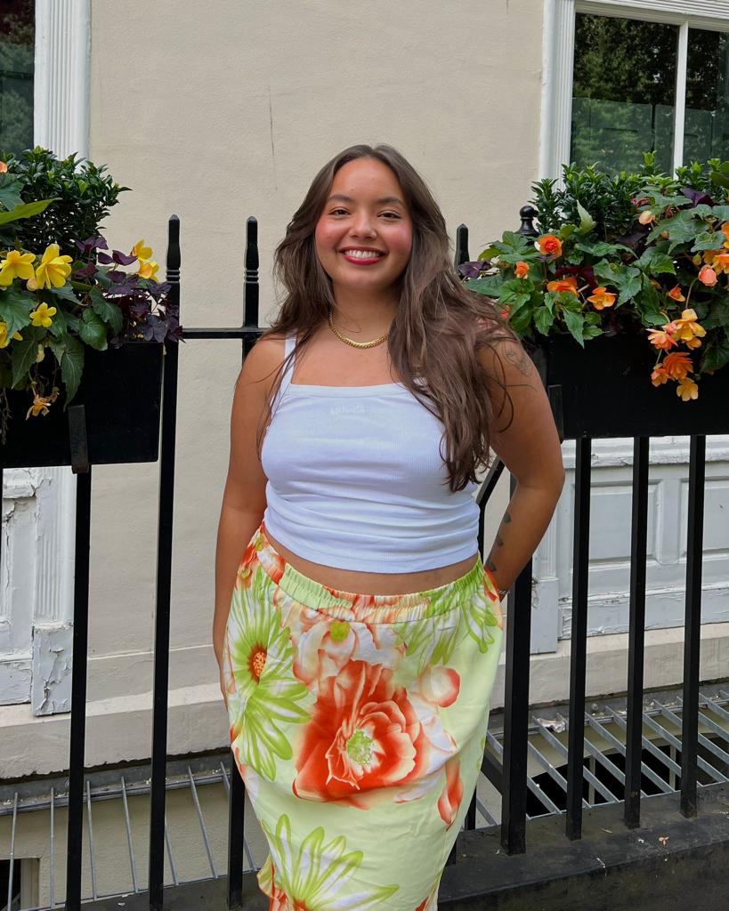 Jasmine Jaffar wearing a vest and skirt
