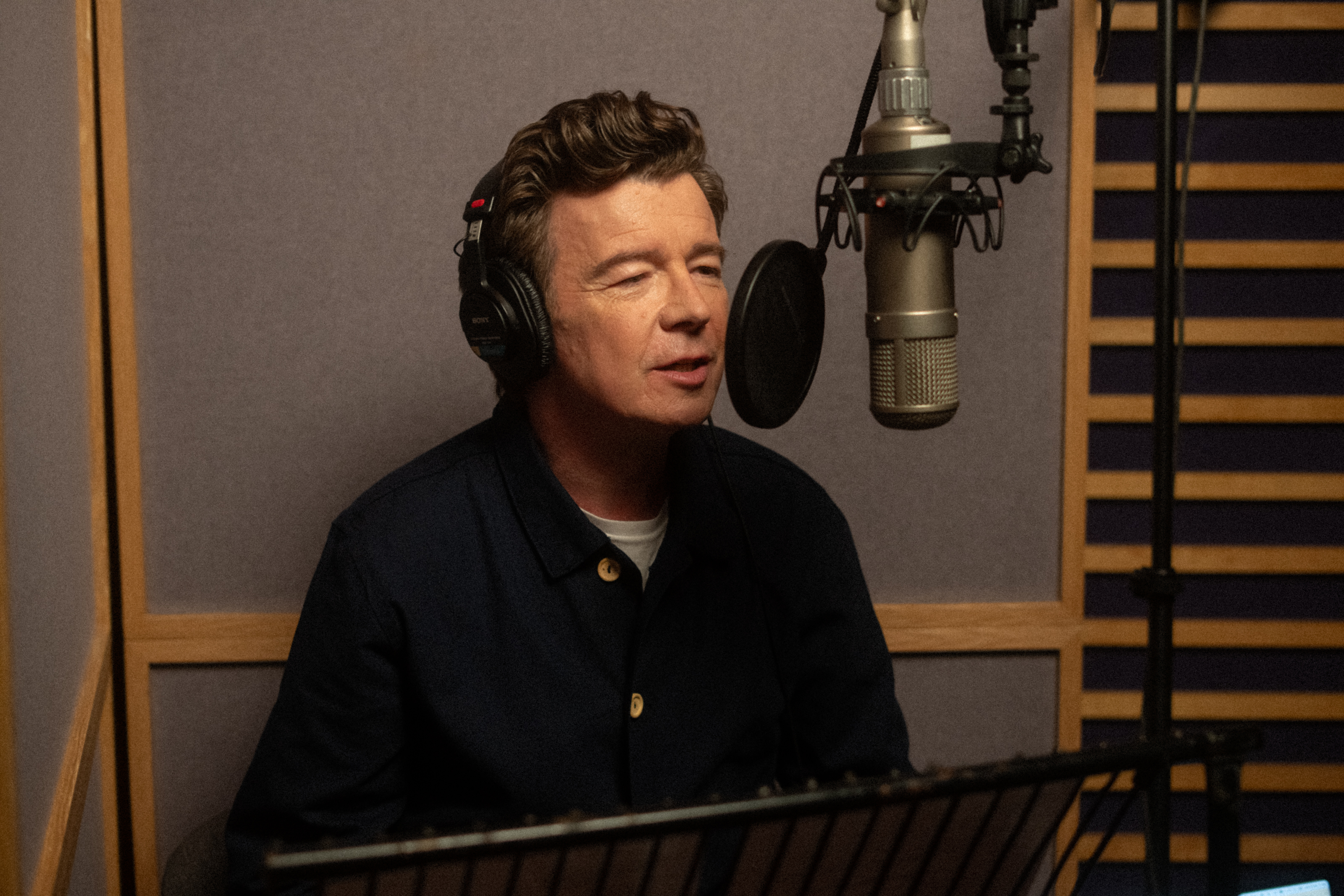 Rick Astley in a recording booth
