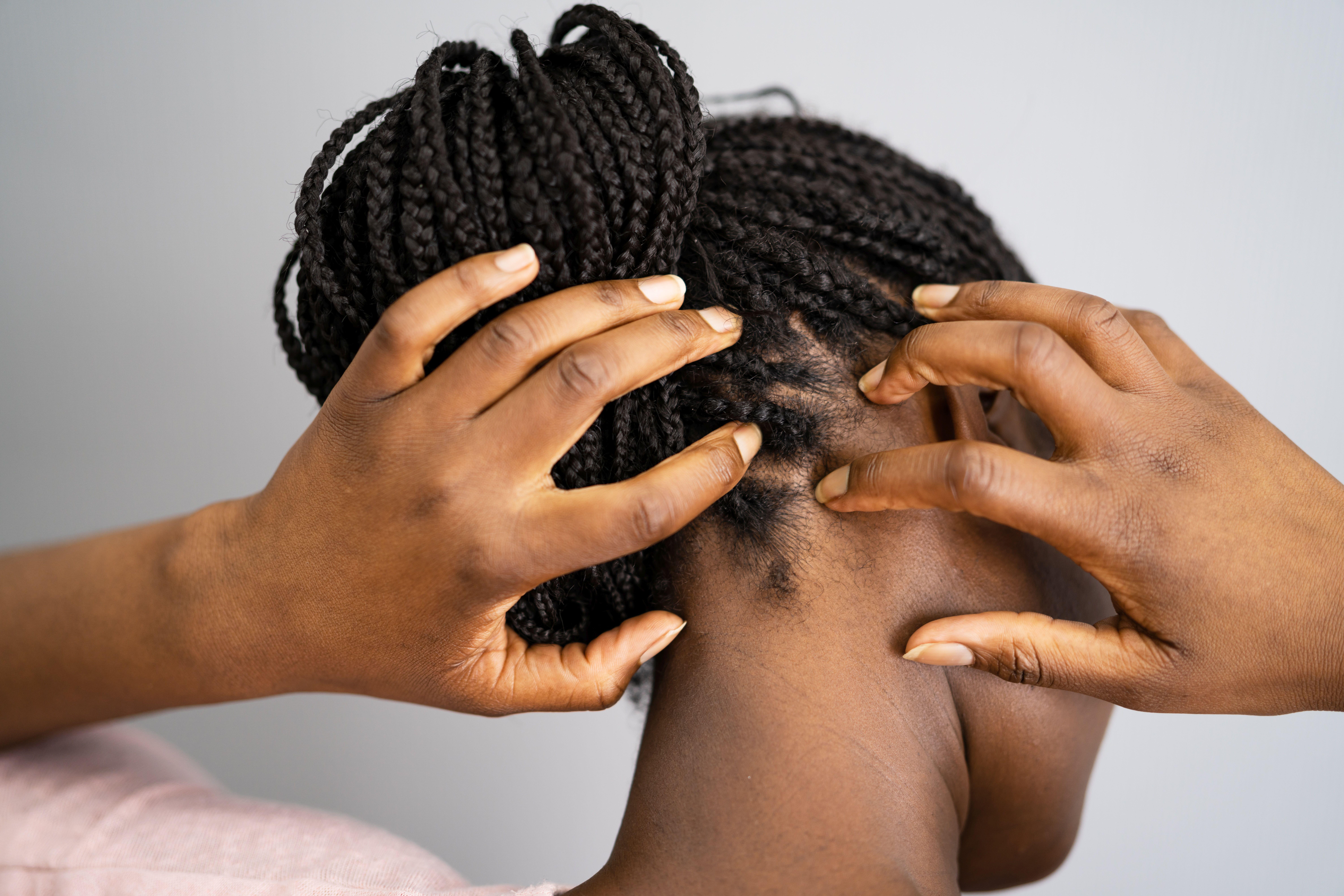 black woman scratching behind ear