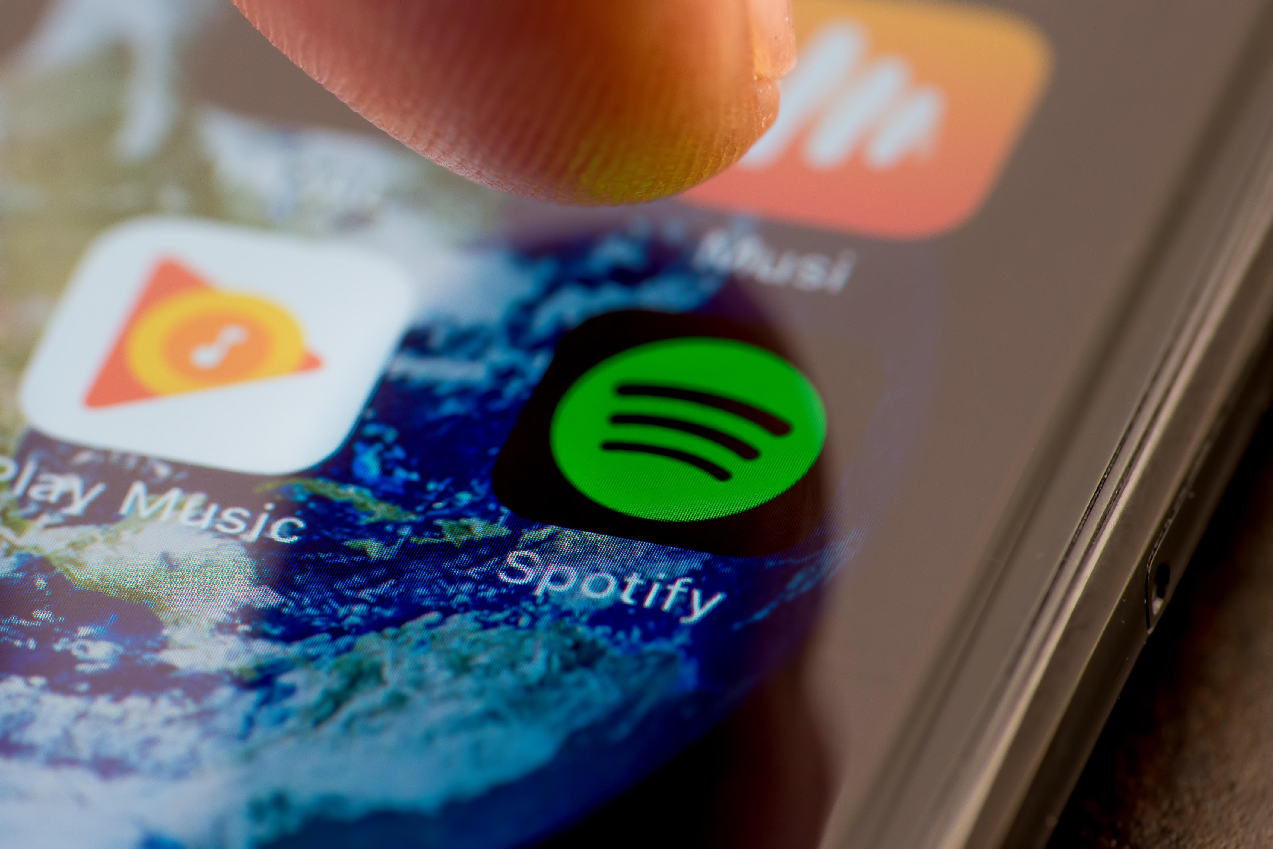 Person using phone to access Spotify app