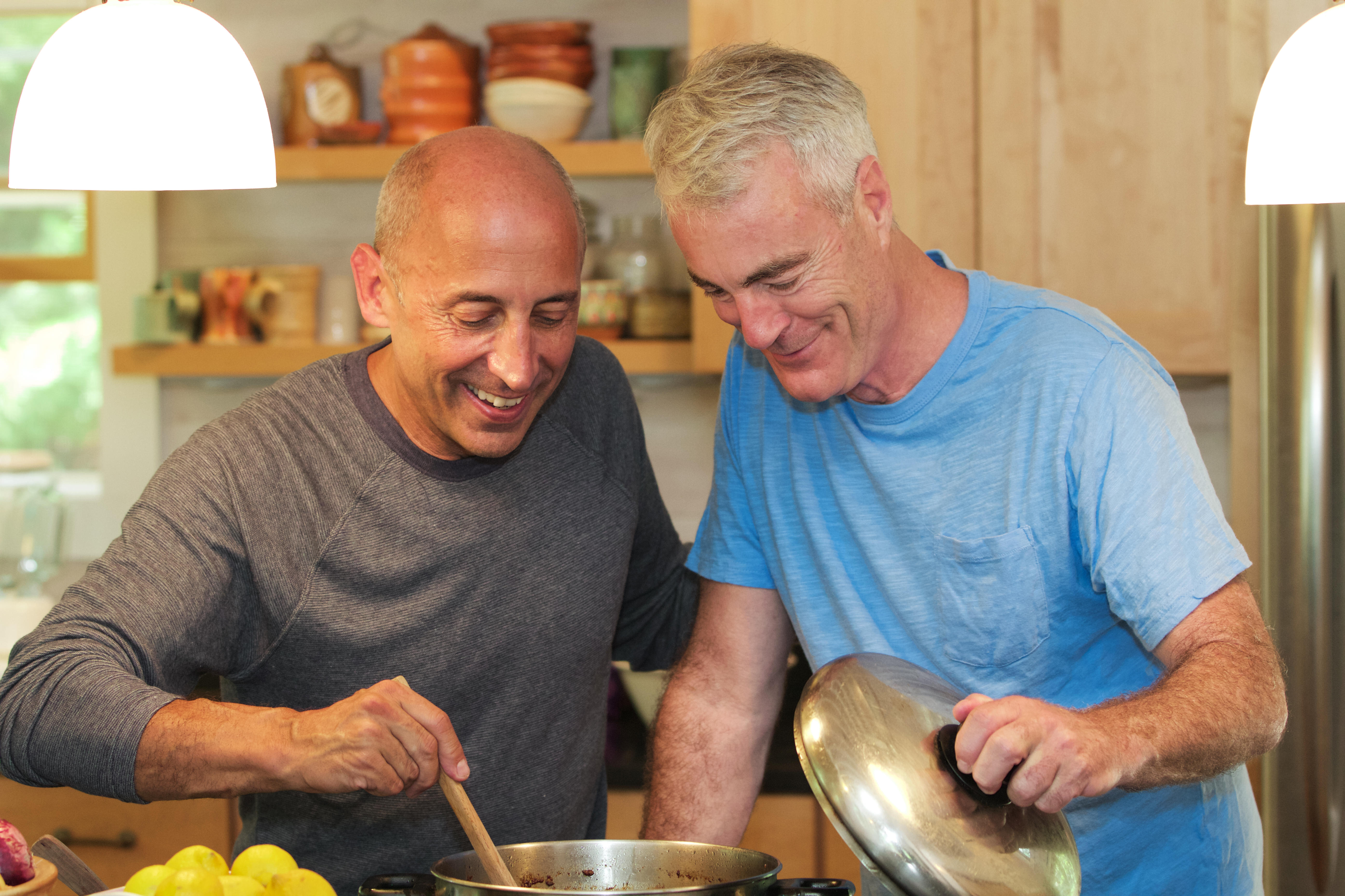Mature gay couple cooking together