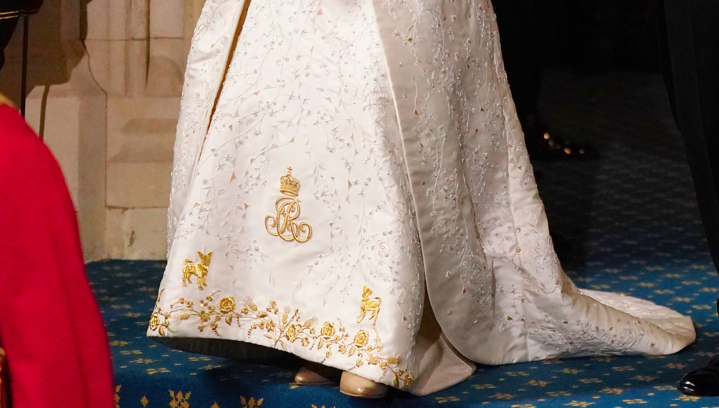 The Queen's coronation dress which features embroidered motifs of her pet dogs - and the names of her grandchildren