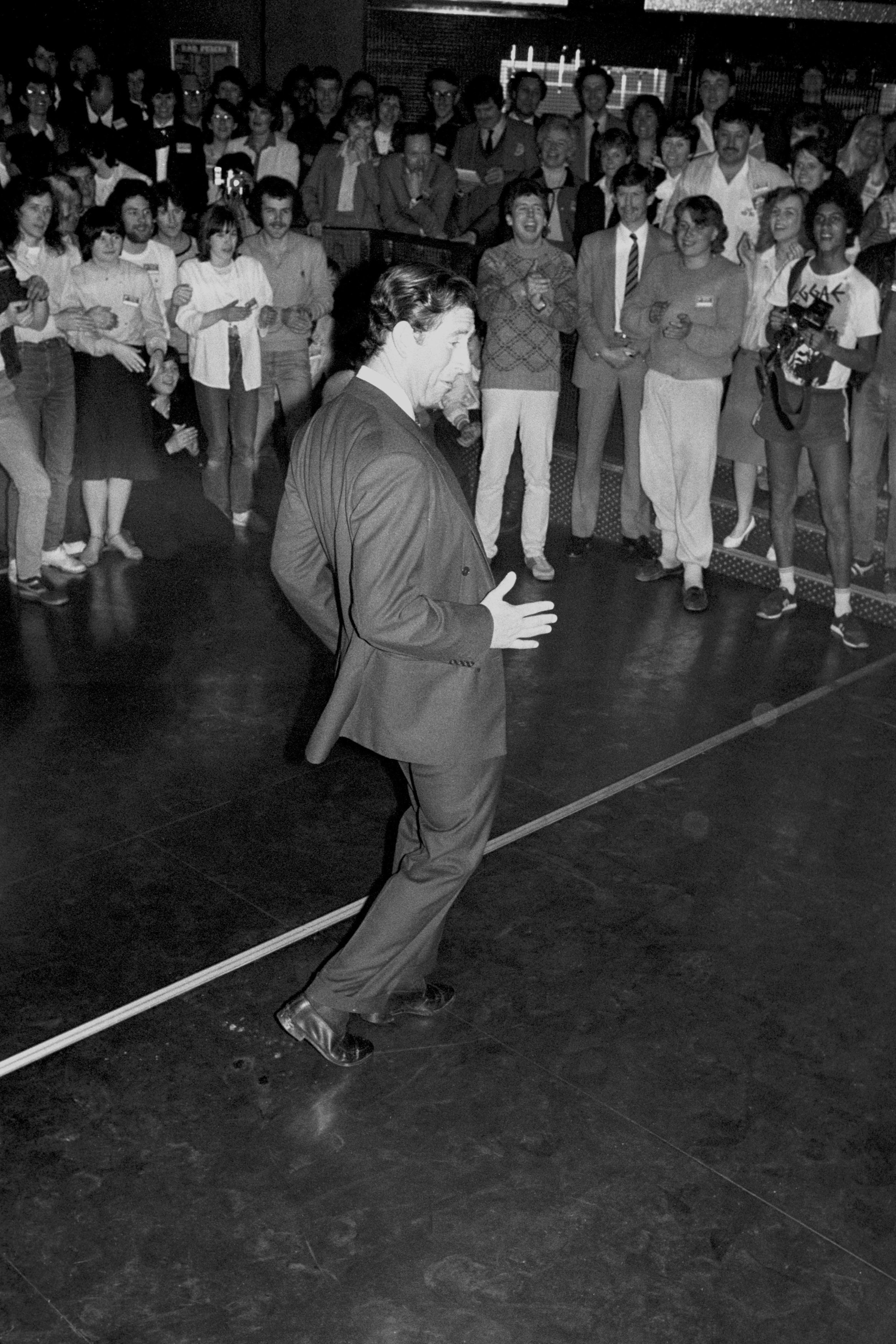 The Prince of Wales trying his hand at breakdancing, to the delight of youngsters at a disco in Middleton-on-Sea