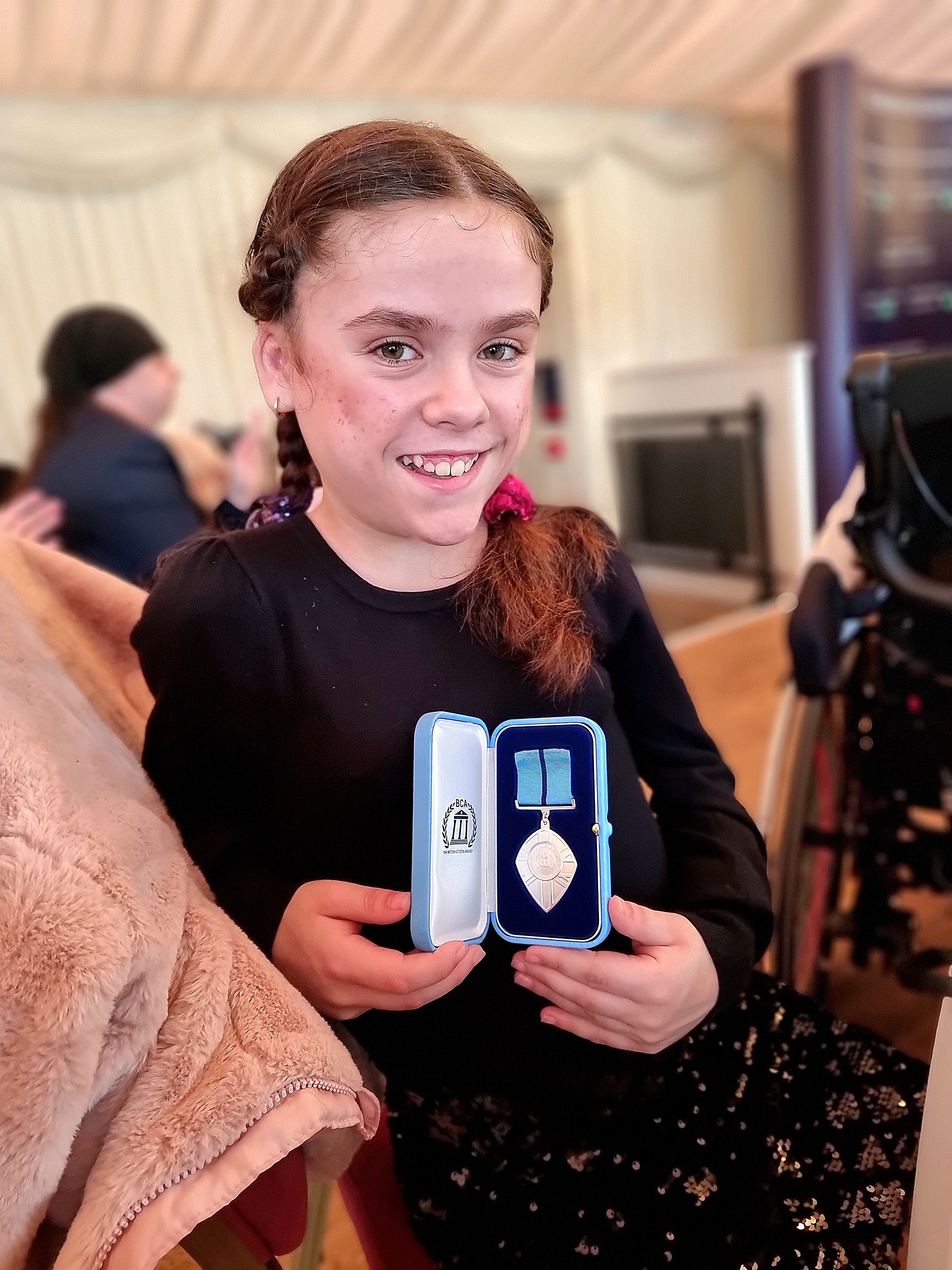 Carmela holding her British Citizen Youth Award