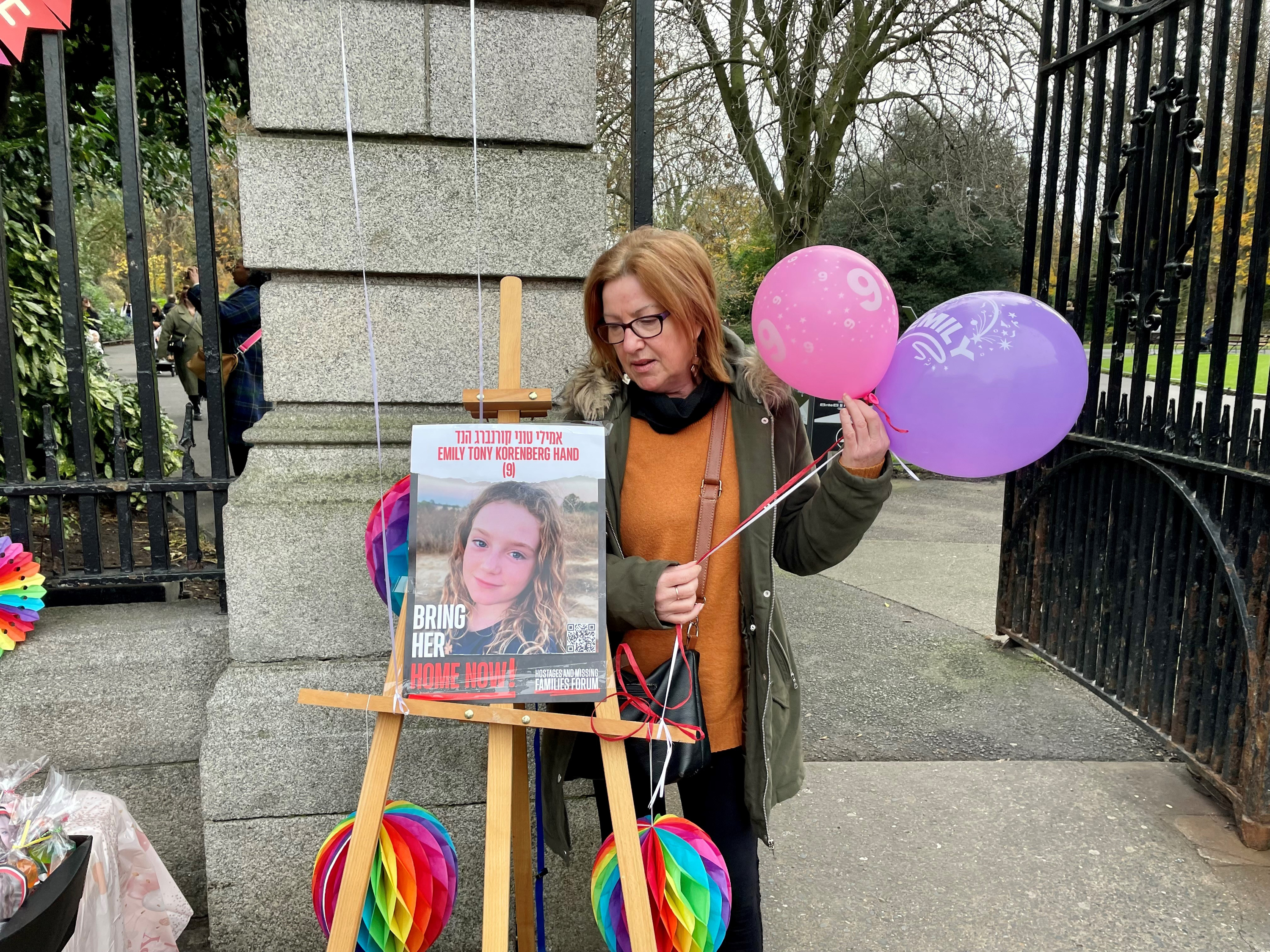 Anna Byrne, a cousin of Emily Hand's father, stands by a birthday spread on a table for the young girl