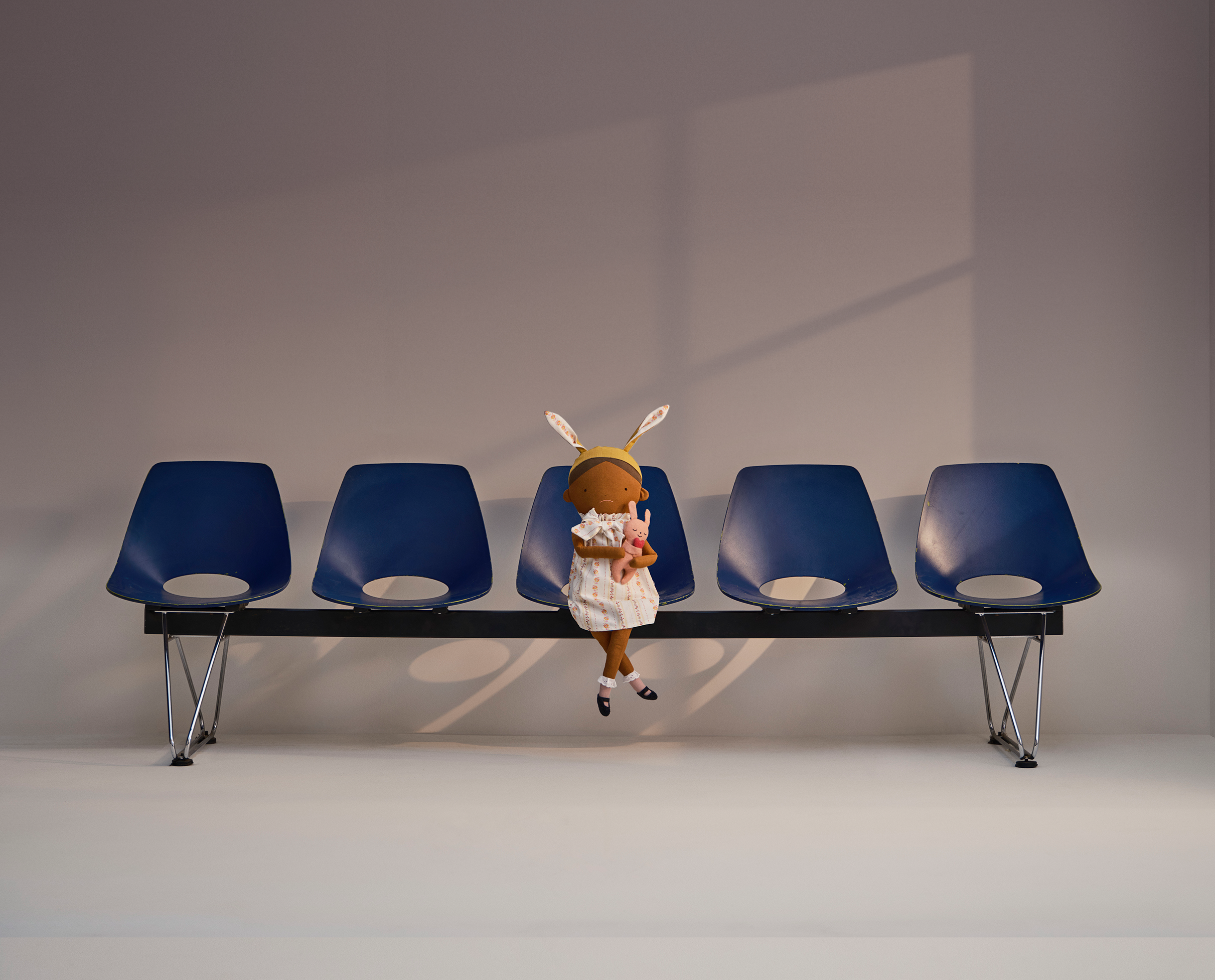 Amelia's doll sitting on some chairs