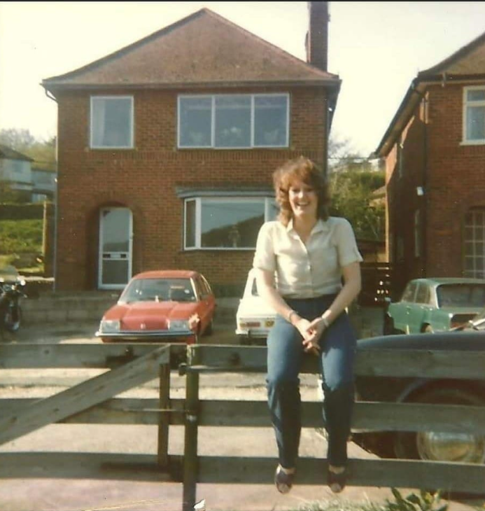 Woman sitting on fence