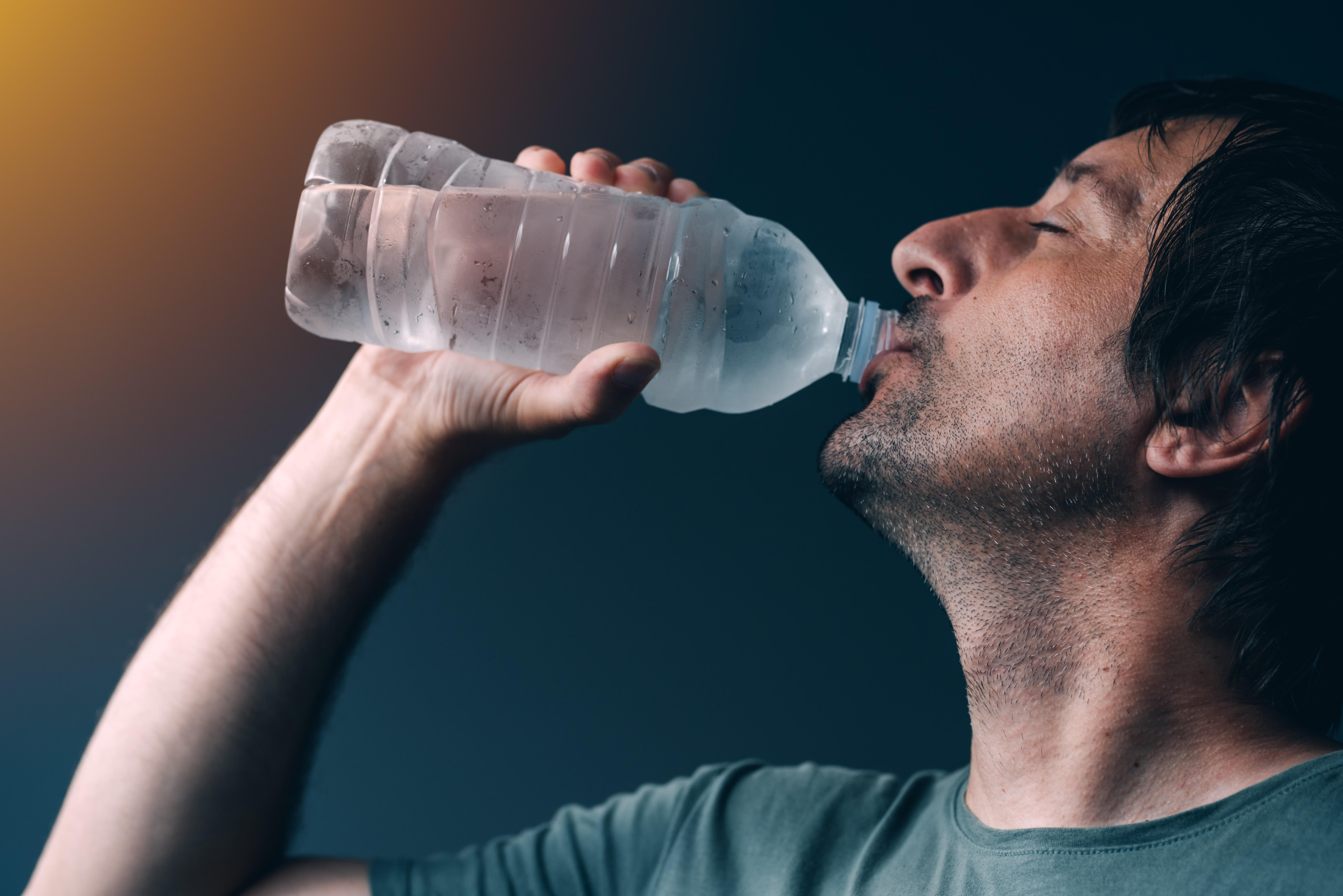A man drinking a bottle of water