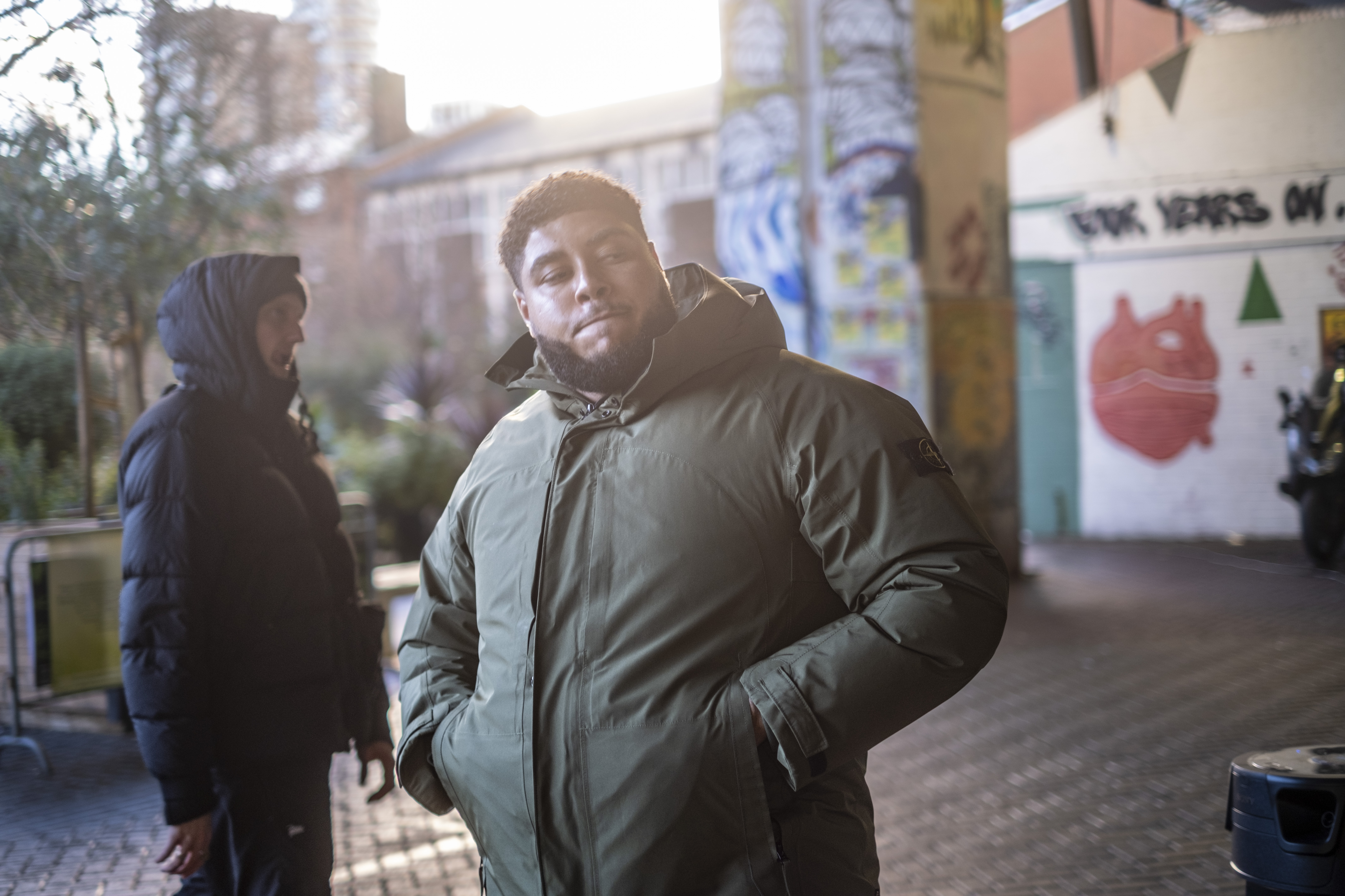 Big Zuu standing in the centre of the frame with Toddla T in the background 