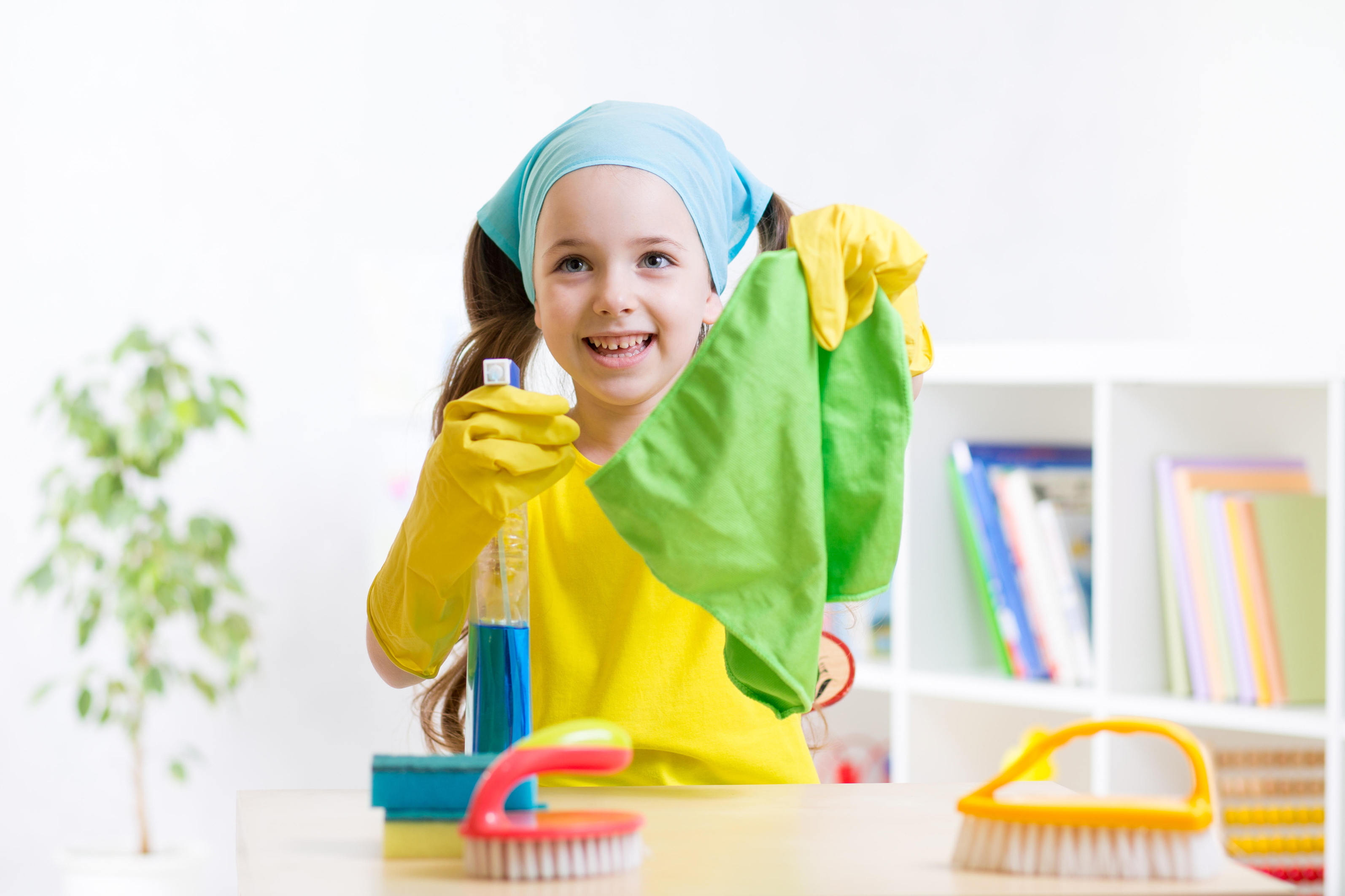 Little girl cleaning at home