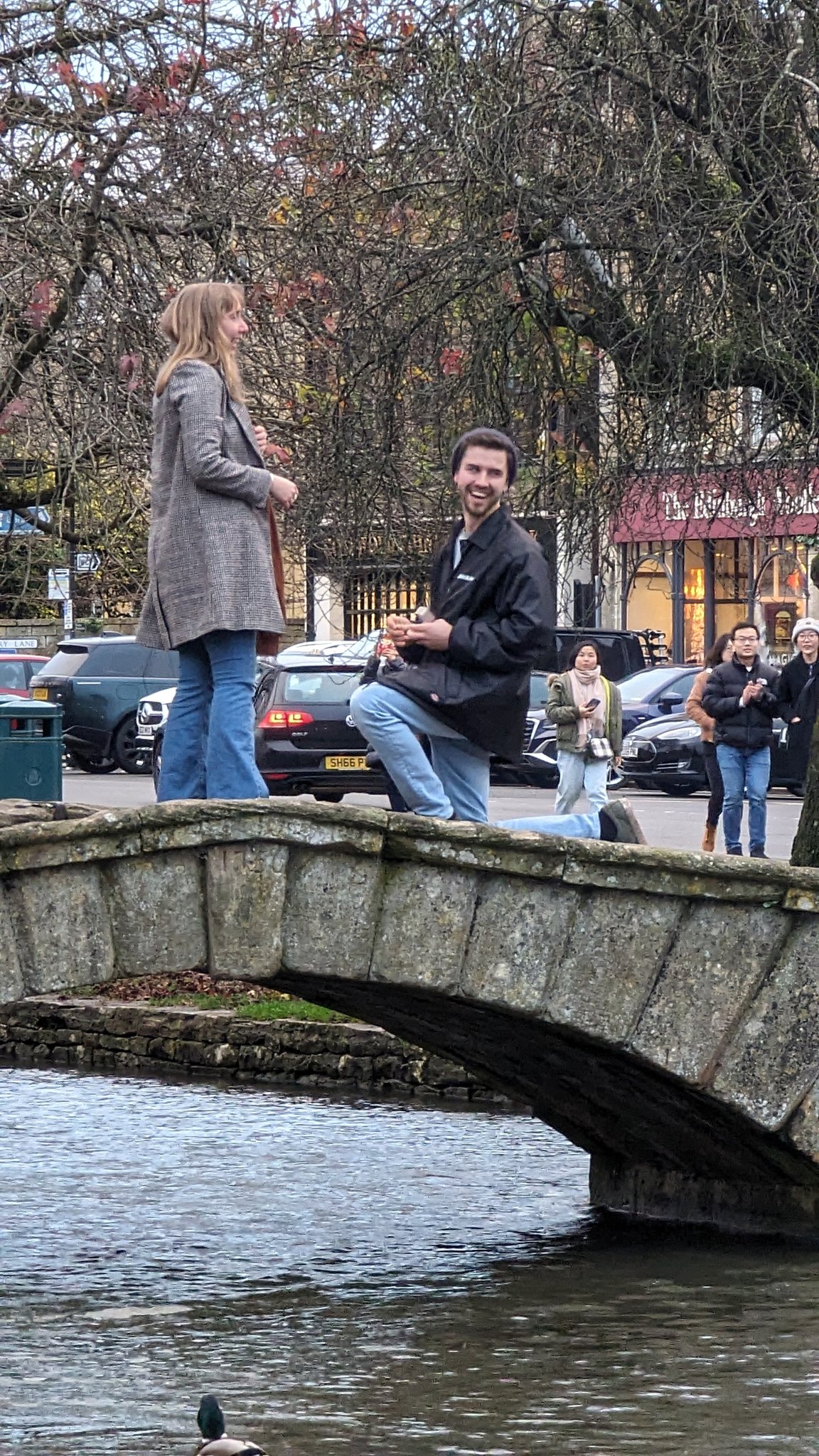 Man on one knee proposing to woman 