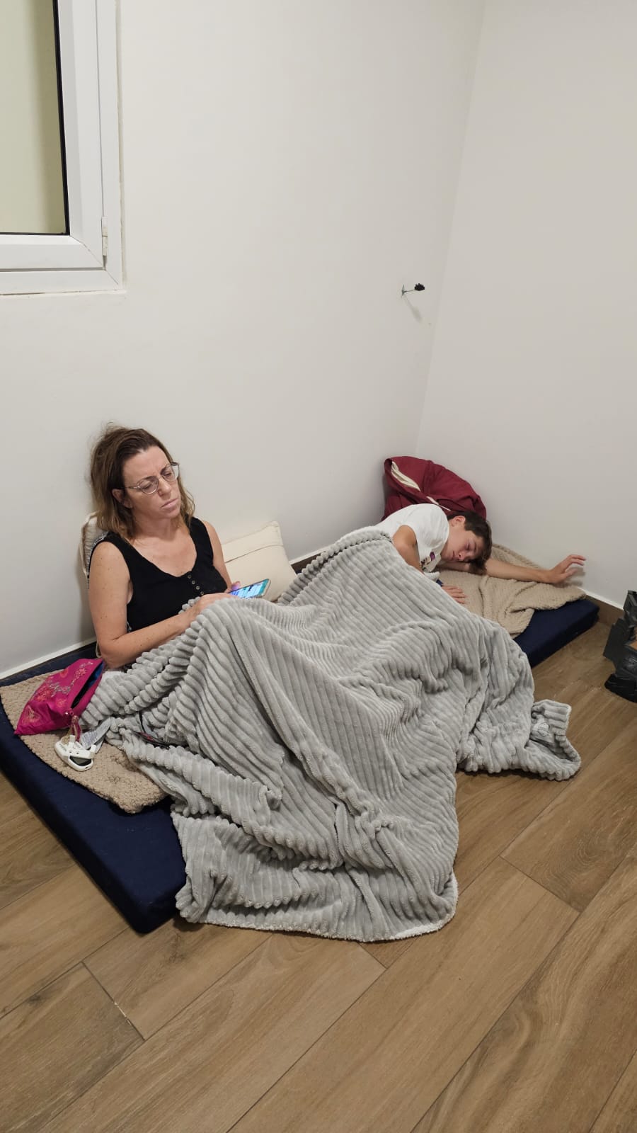 Simon's wife and his son in their safe room lying on a mattress