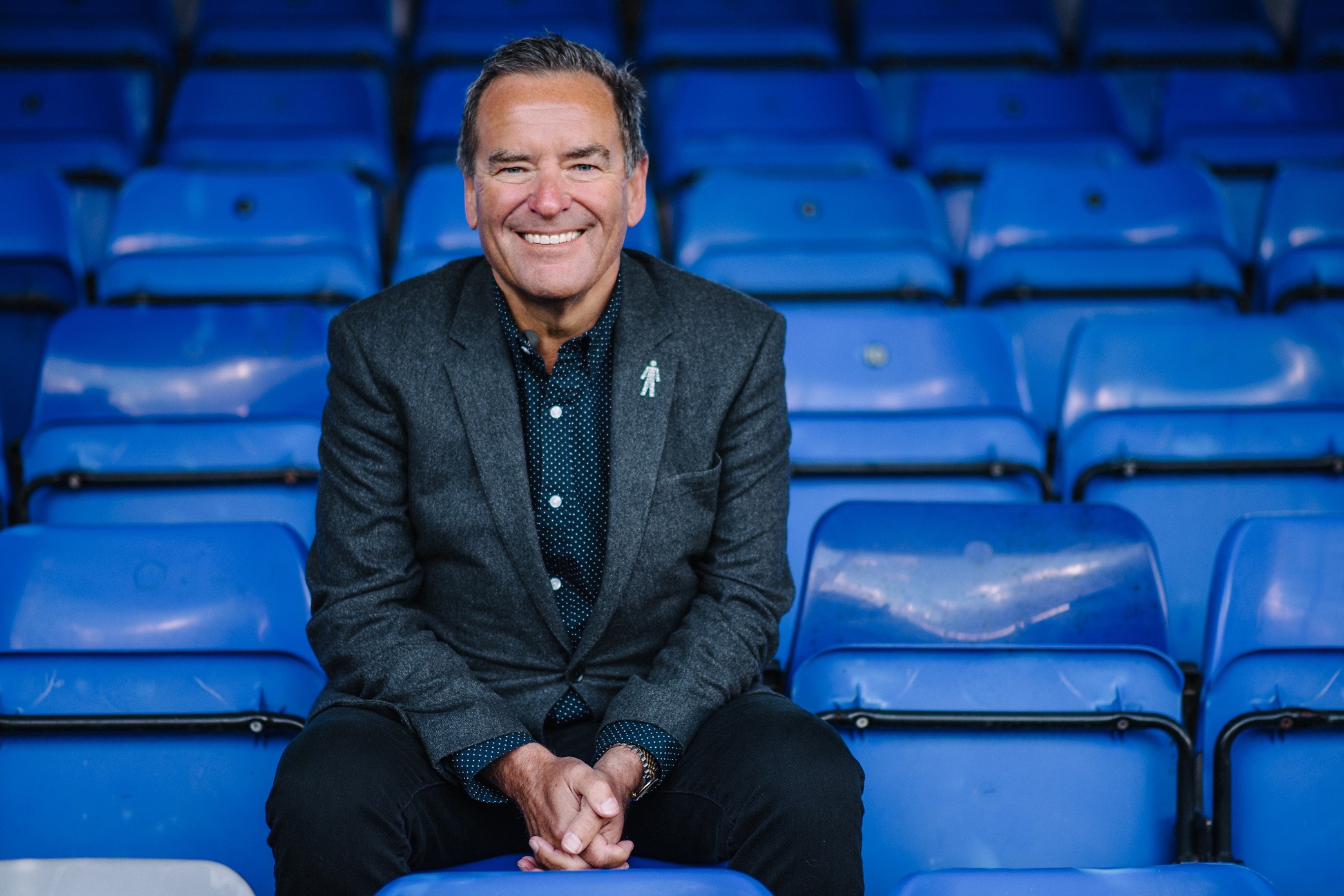 Jeff Stelling pictured wearing the charity's 'Man of Men' badge