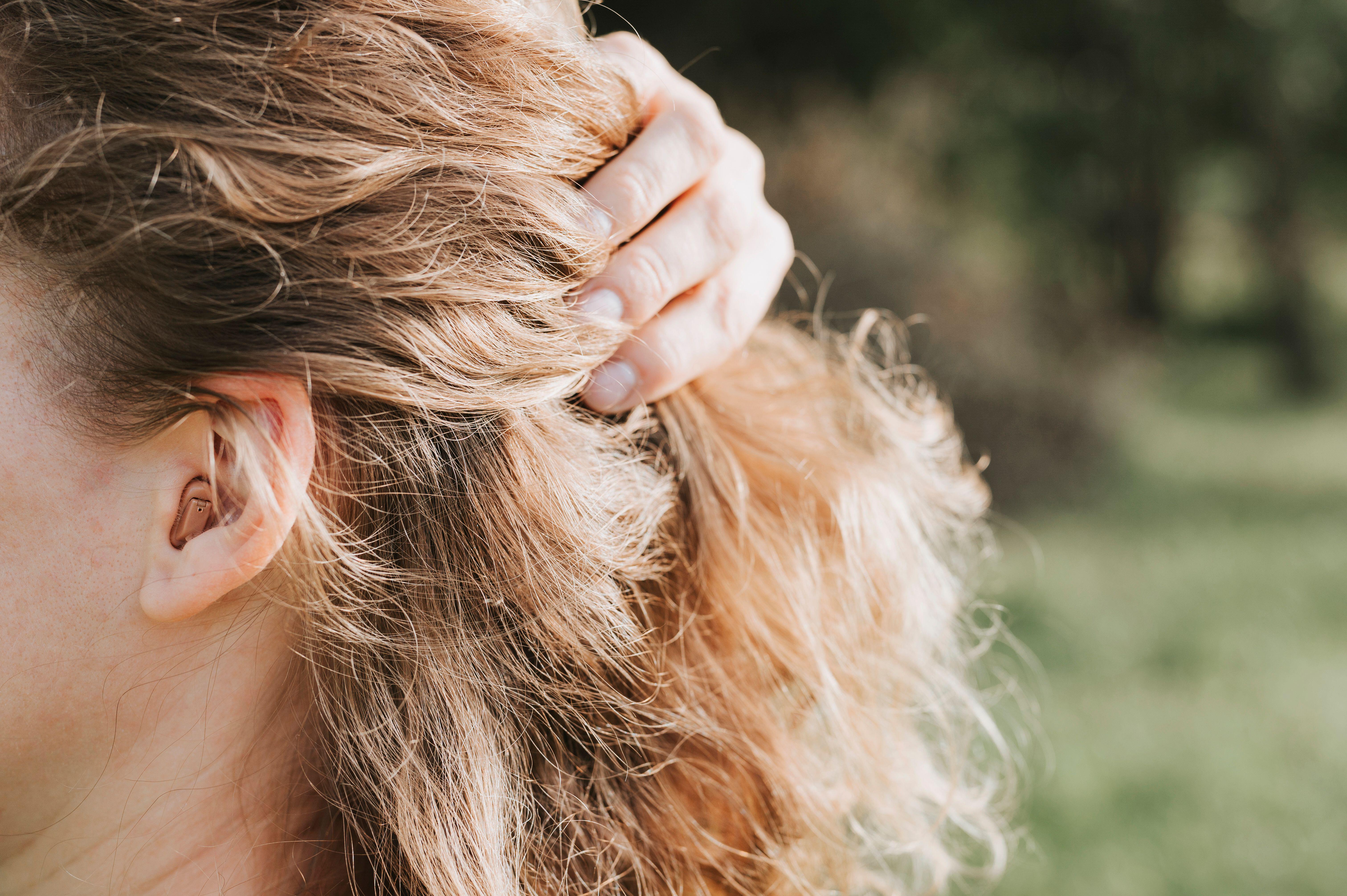 Small intra channel hearing aid in the ear of a woman (Alamy/PA)