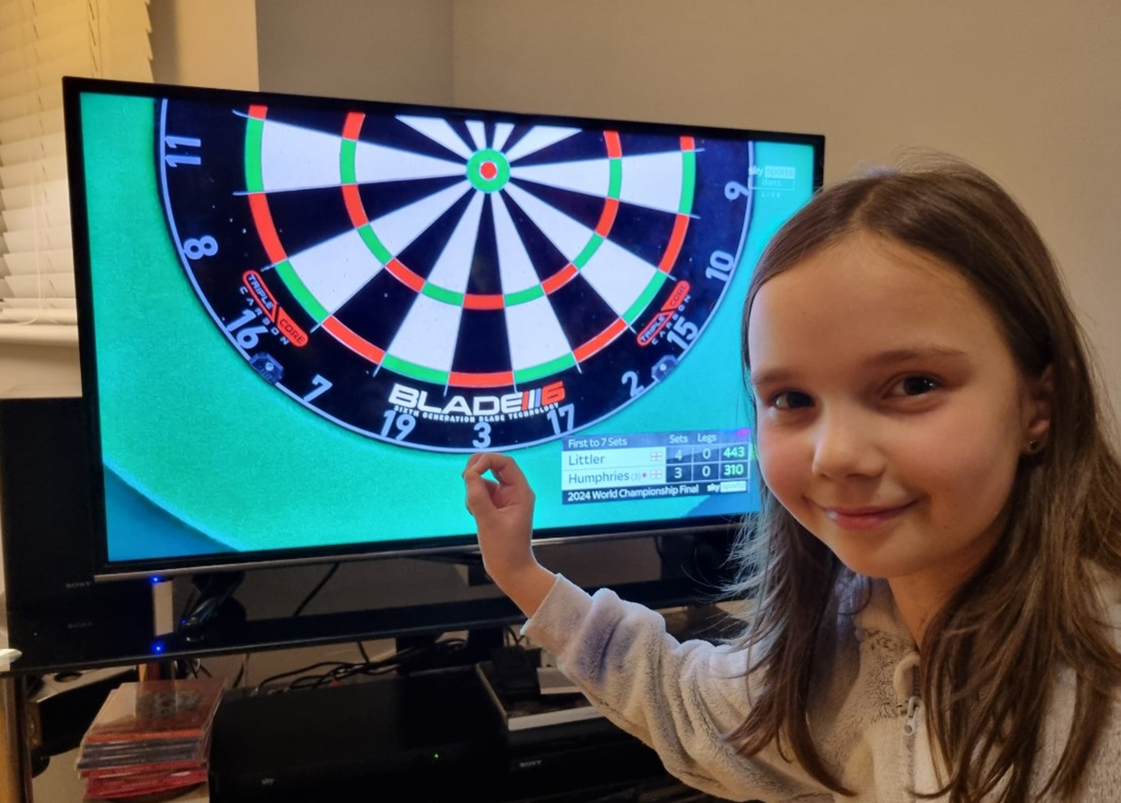 Lyla Edwards, nine, enjoys the darts final