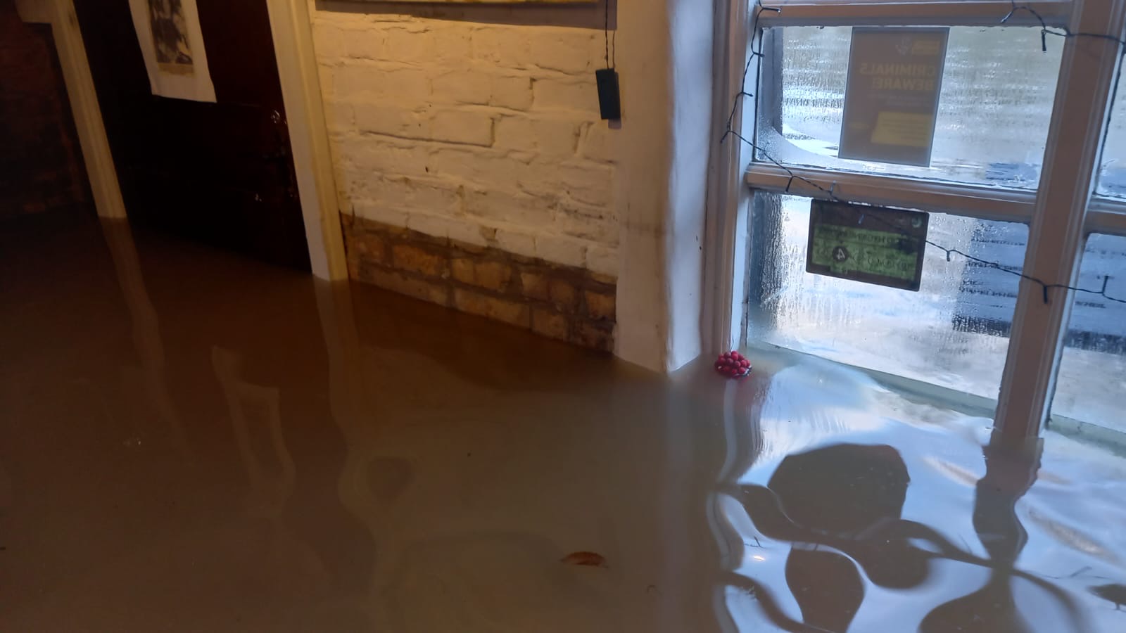Inside The Boat Inn with flood water reaching the windows 