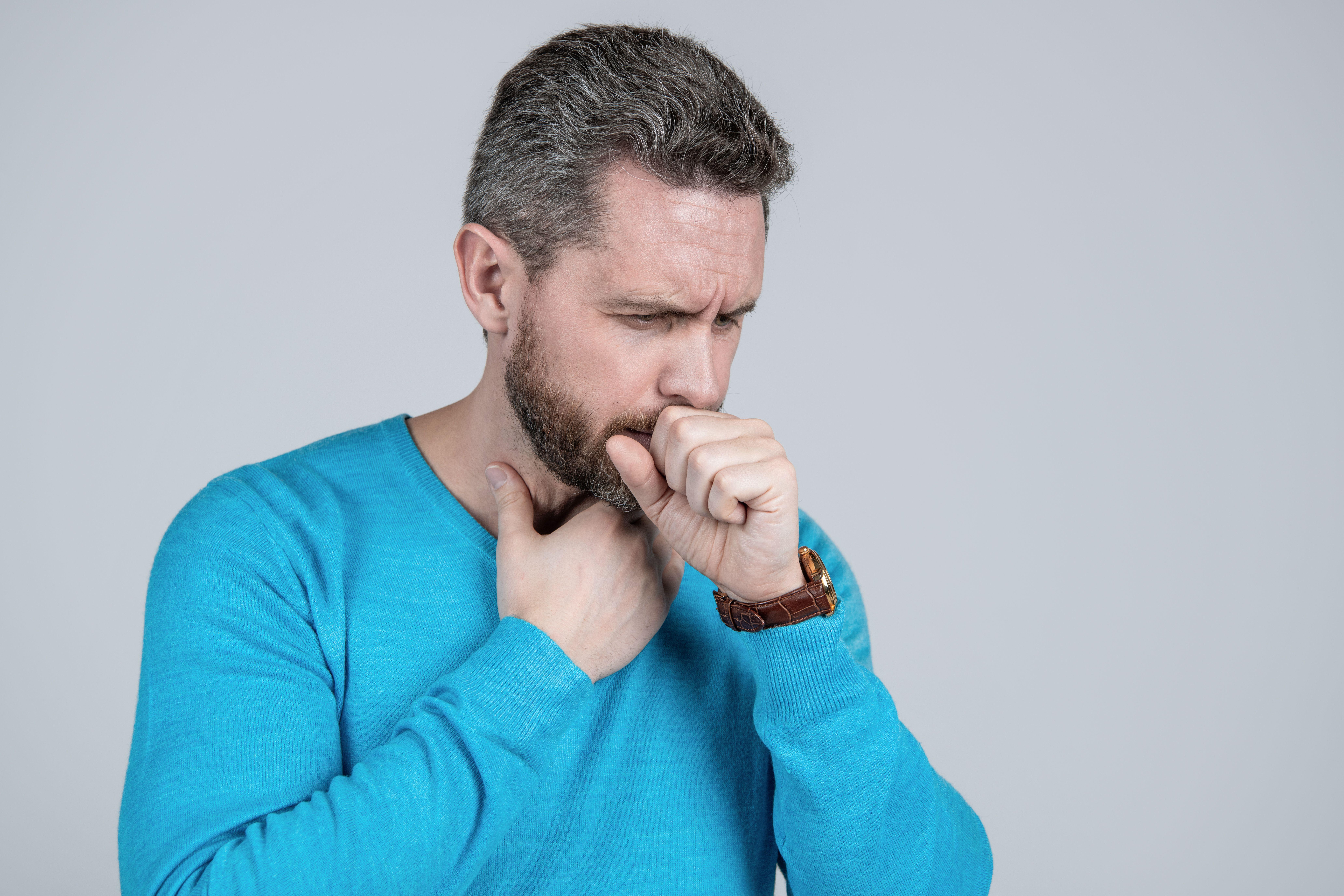 A man coughing