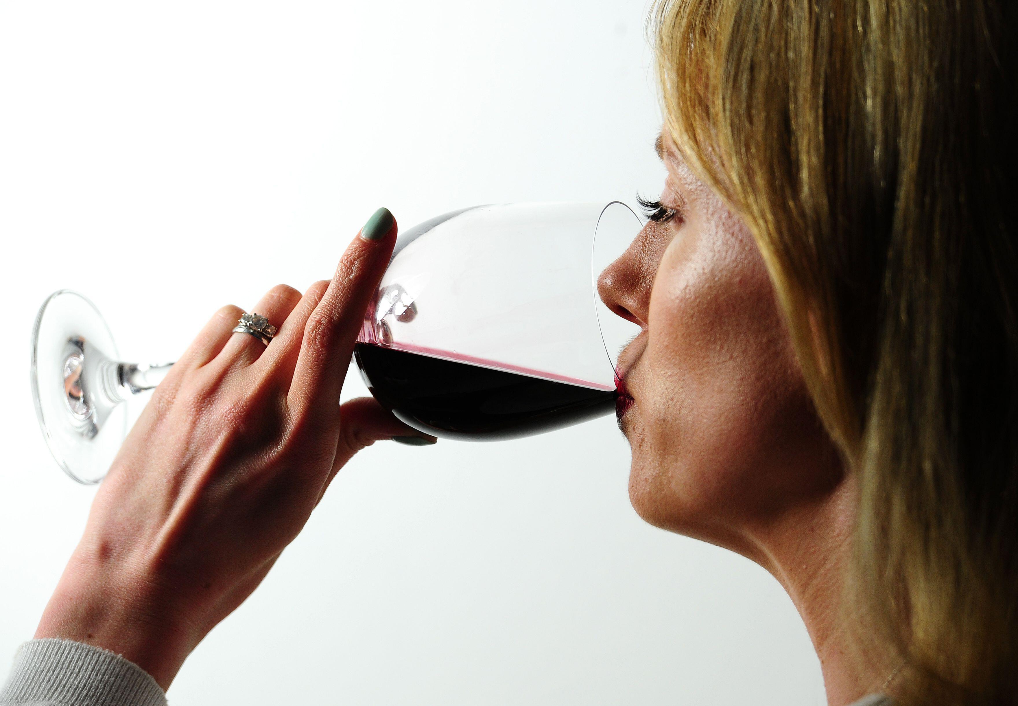 Woman drinking wine (Alamy/PA)