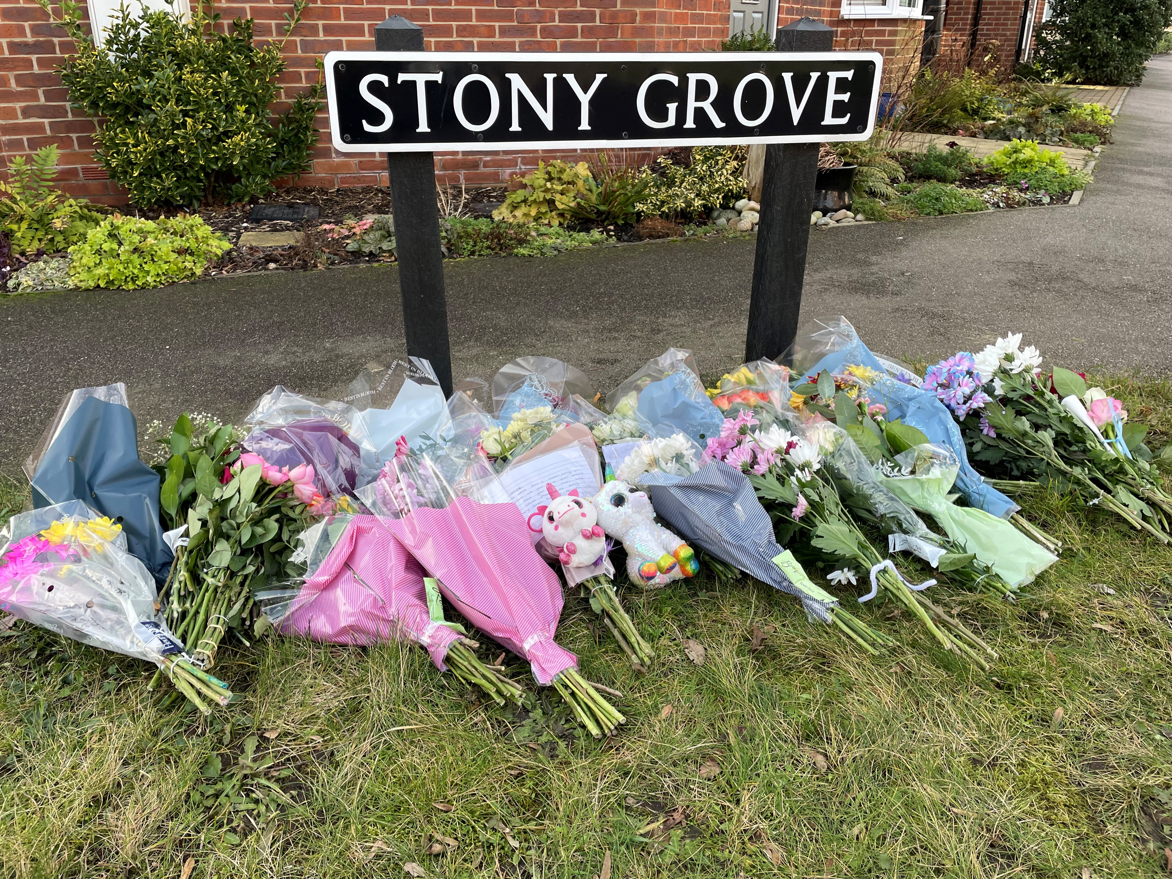 Floral tributes have been left by the sign for Stony Grove, near to the house in Allan Bedford Crescent in Costessey, Norfolk. (Sam Russell/ PA)