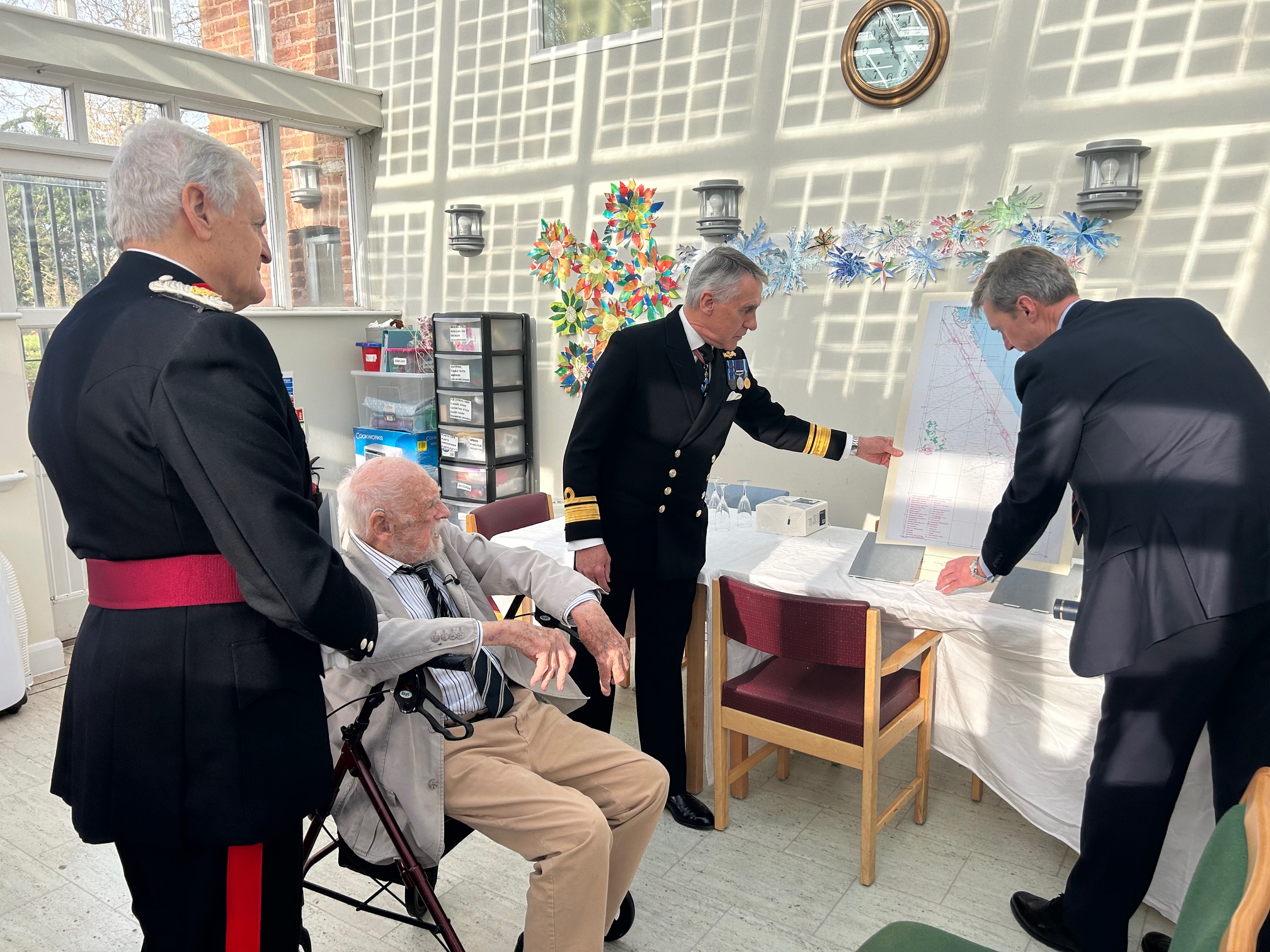 D-Day veteran Lieutenant Richard Willis RN is presented with a D-Day chart of the Utah beach landings to mark his 100th birthday (Lord-Lieutenant of Somerset/PA)