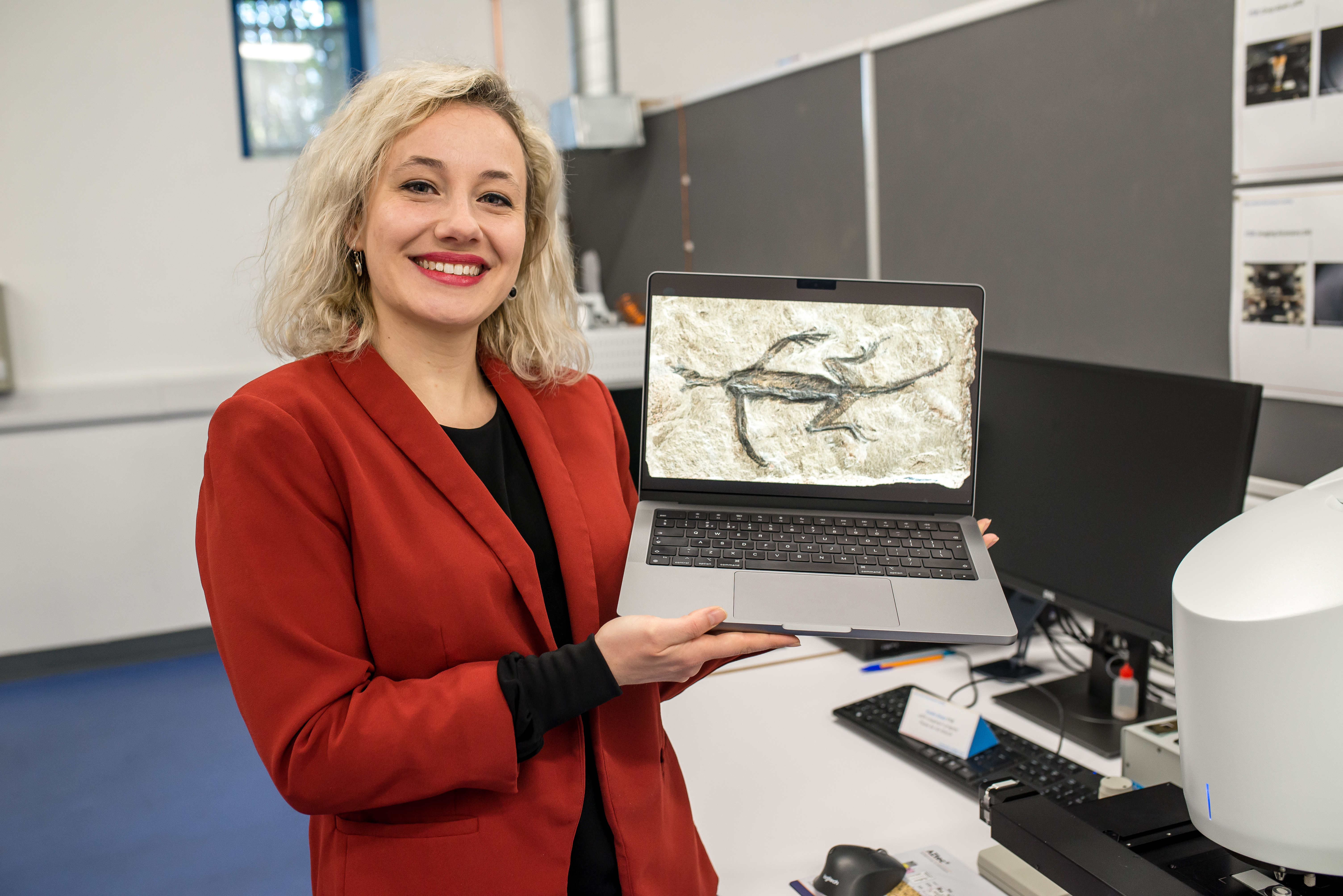 Dr Valentina Rossi with an image of Tridentinosaurus antiquus
