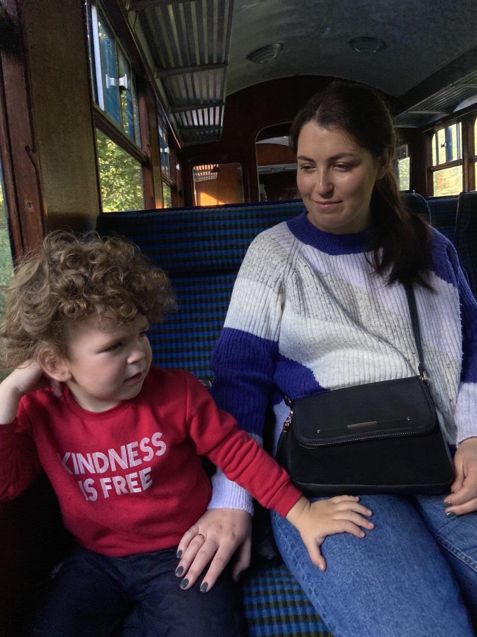 A photo of Nelia Umney with her son Jonathan sitting on a train