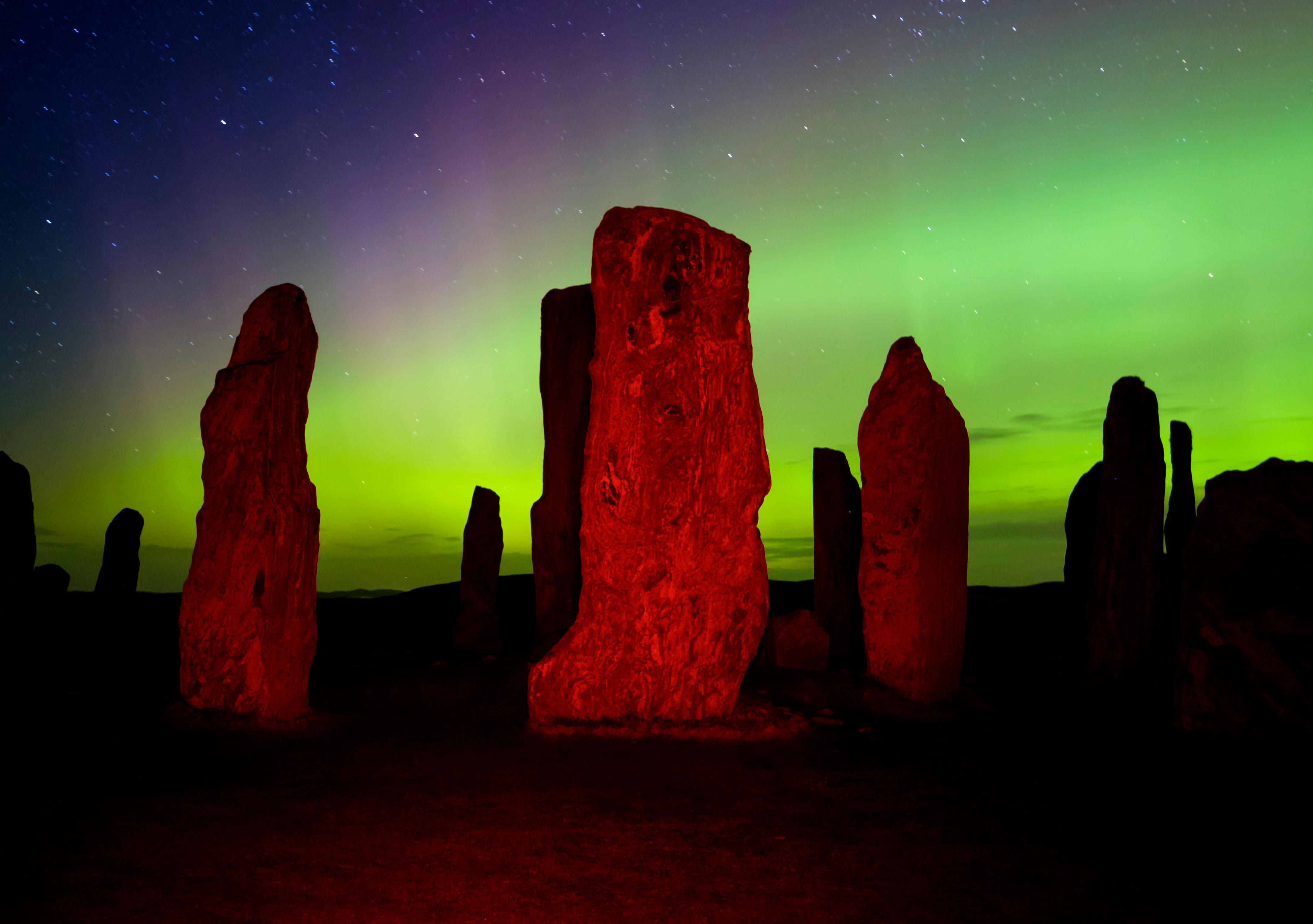 Lights over the famous Callanish Stones in Lewis (Alamy/PA)