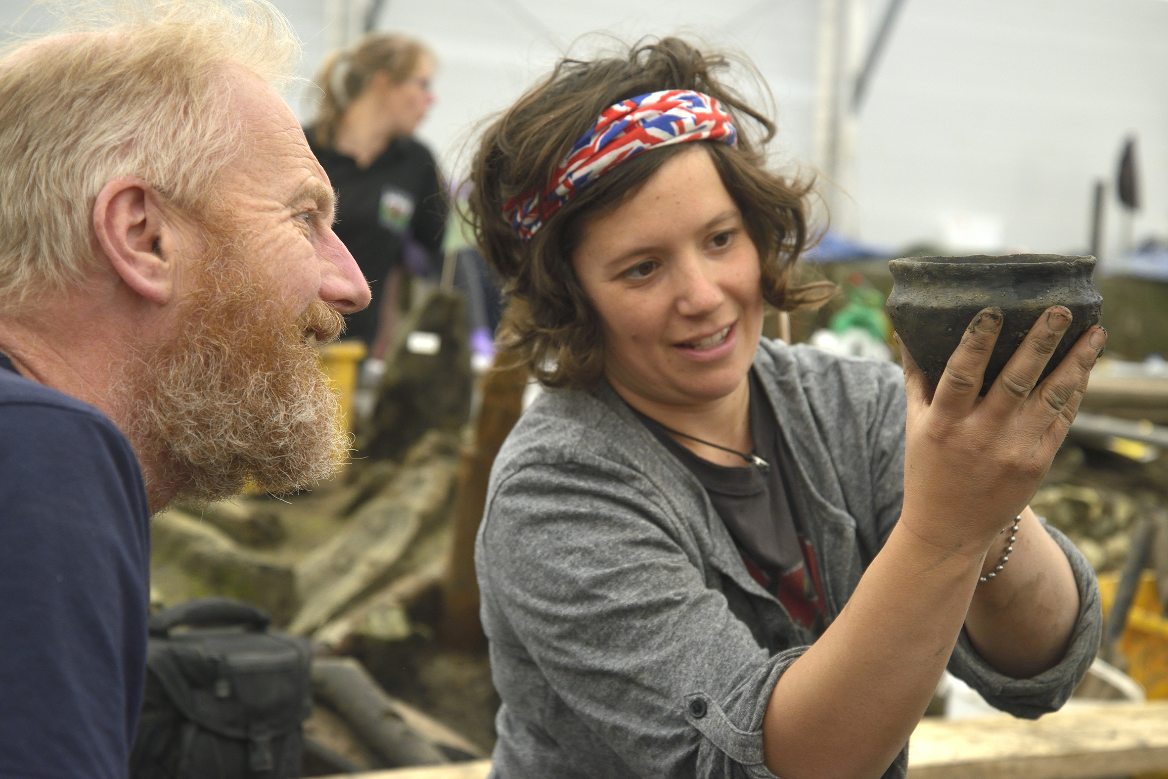 Archaeologists examine a Bronze Age bowl. (Cambridge Archaeological Unit/ PA)
