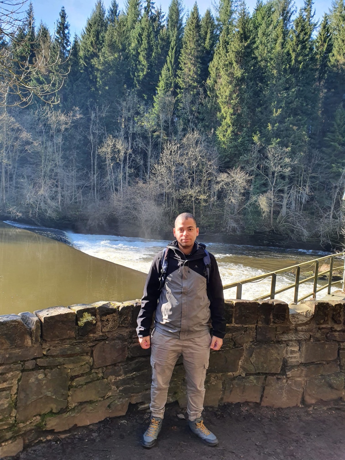 A photo of Mahmoud Almassri standing in front of a lake in Scotland 