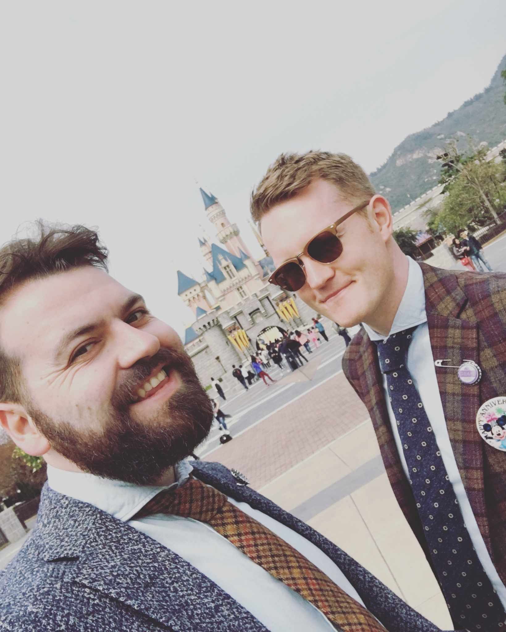 Same-sex couple taking a selfie at a theme park