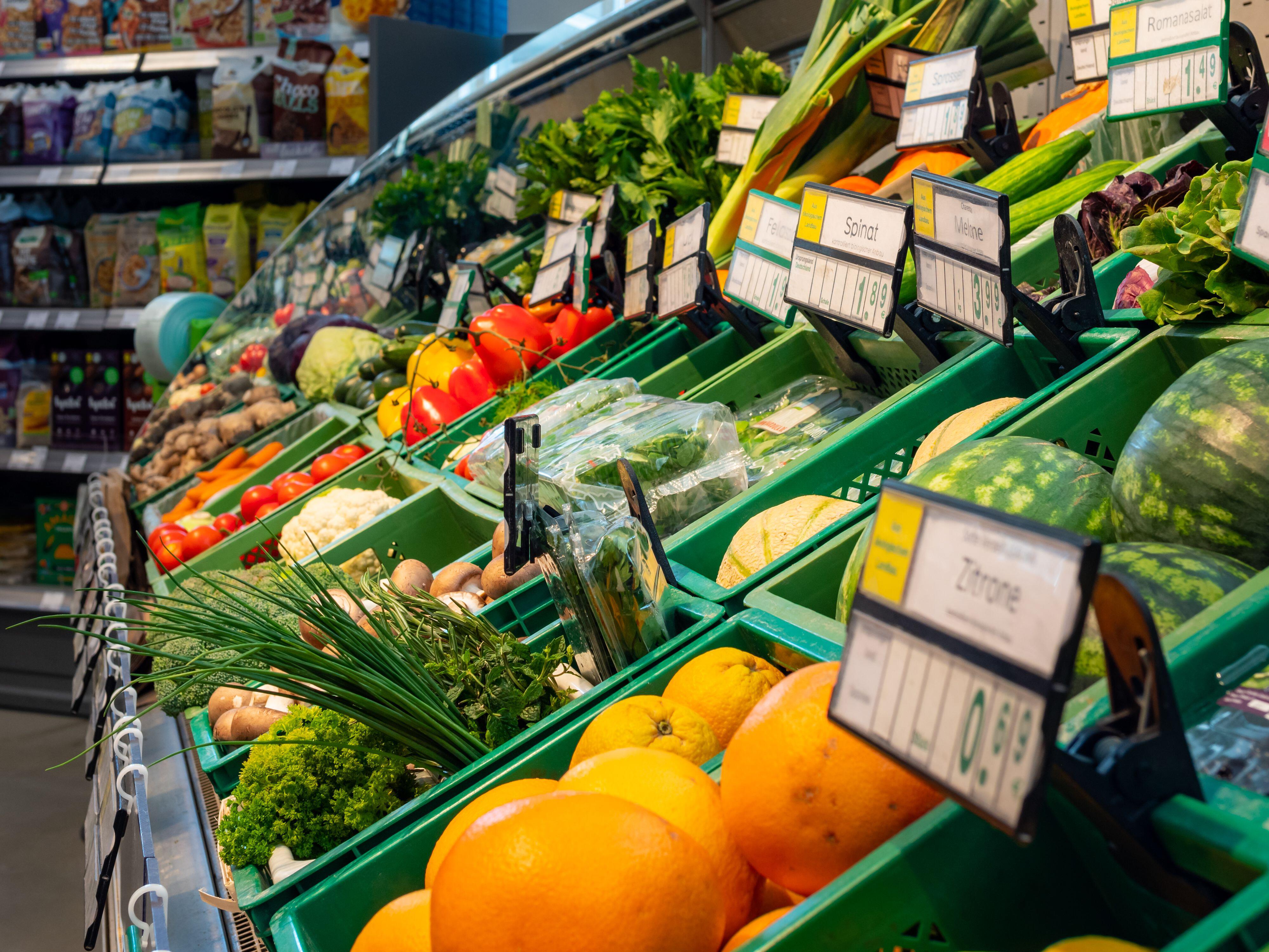 Fresh vegetables and fruits on shelves in a supermarket