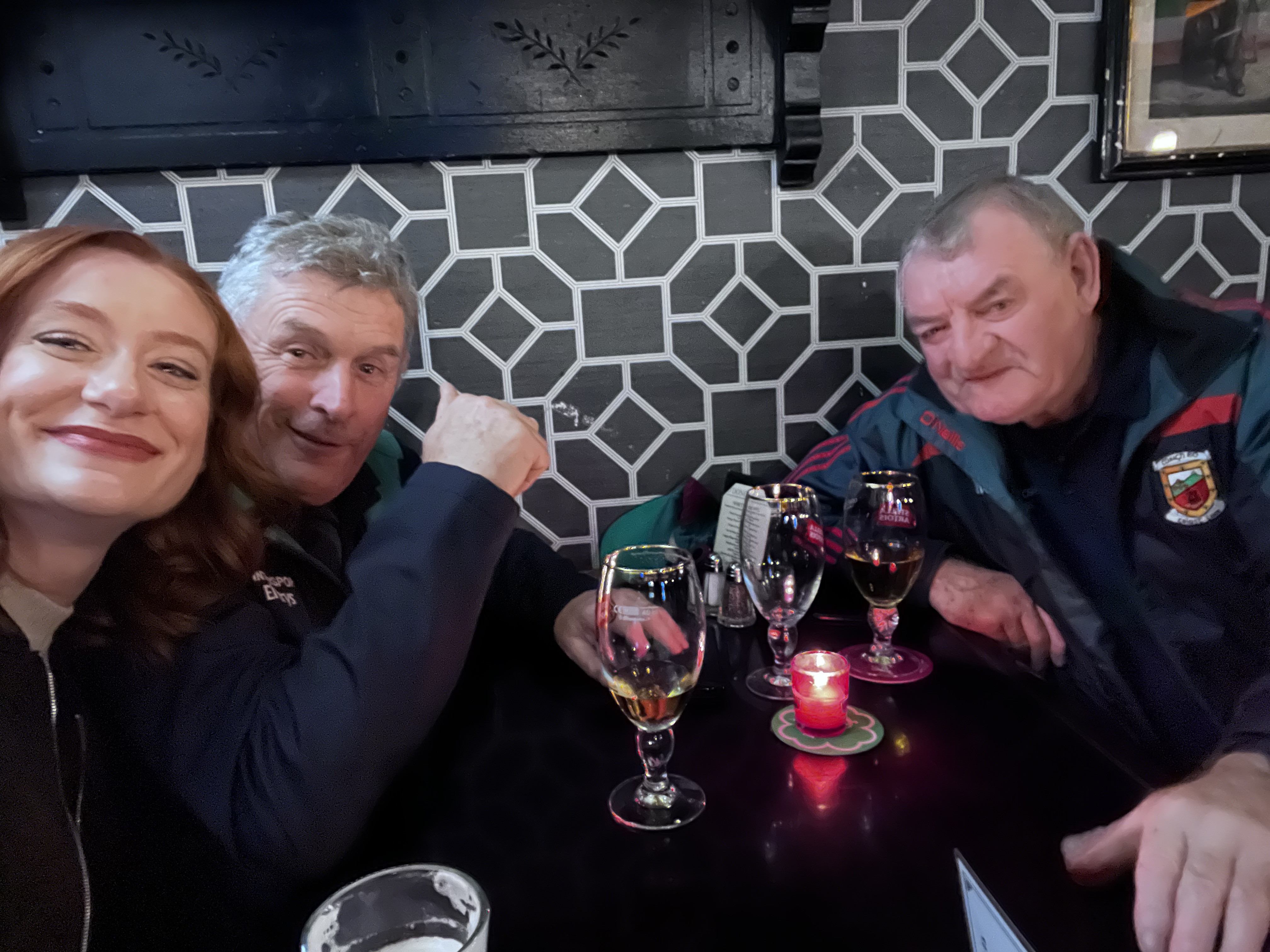 Woman and three men enjoying lunch together