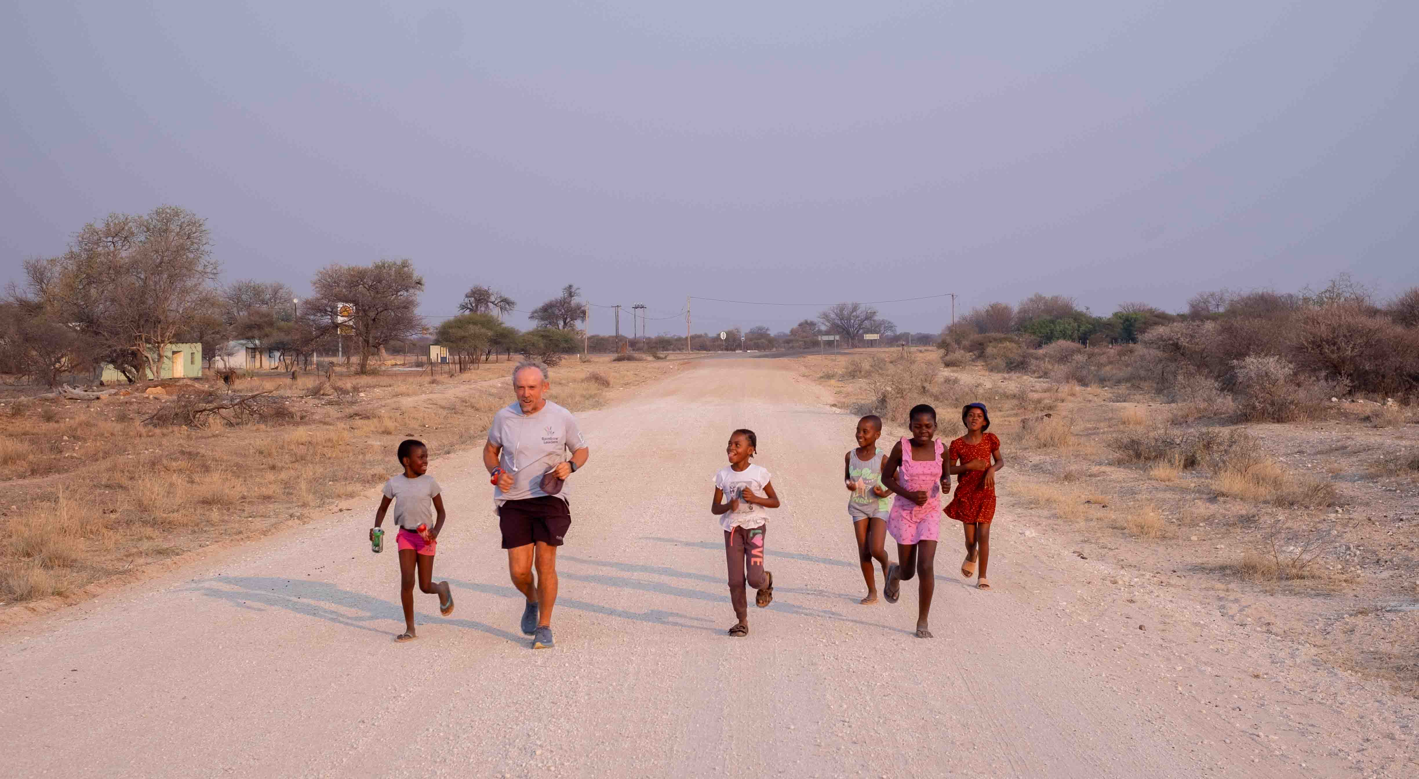 Man runs with children in Africa