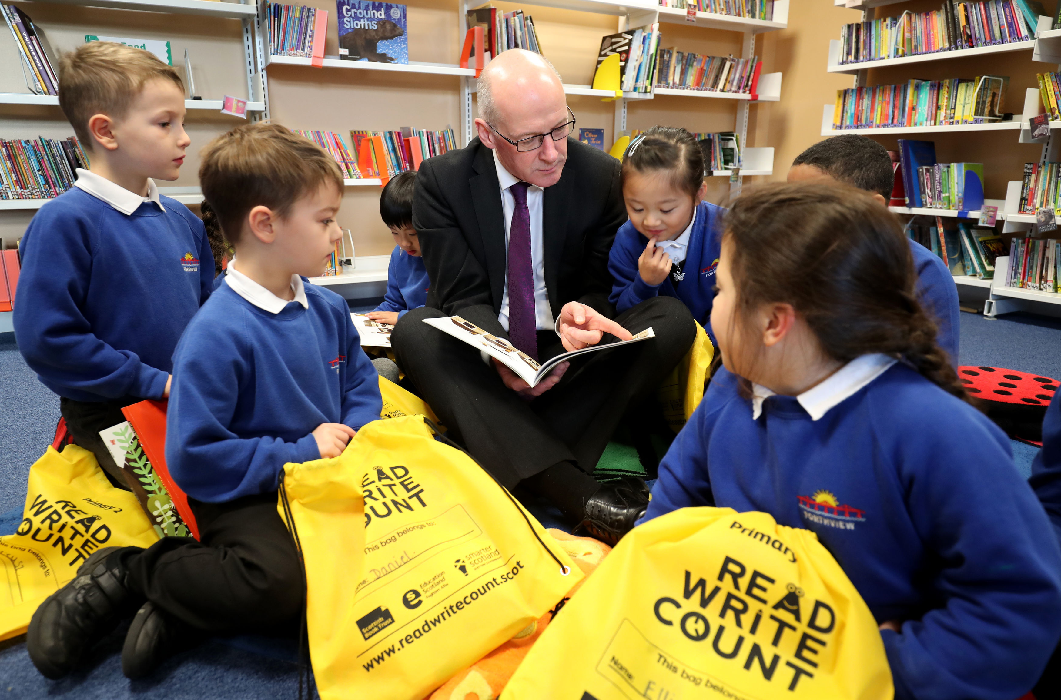 First Minister John Swinney with schoolchildren