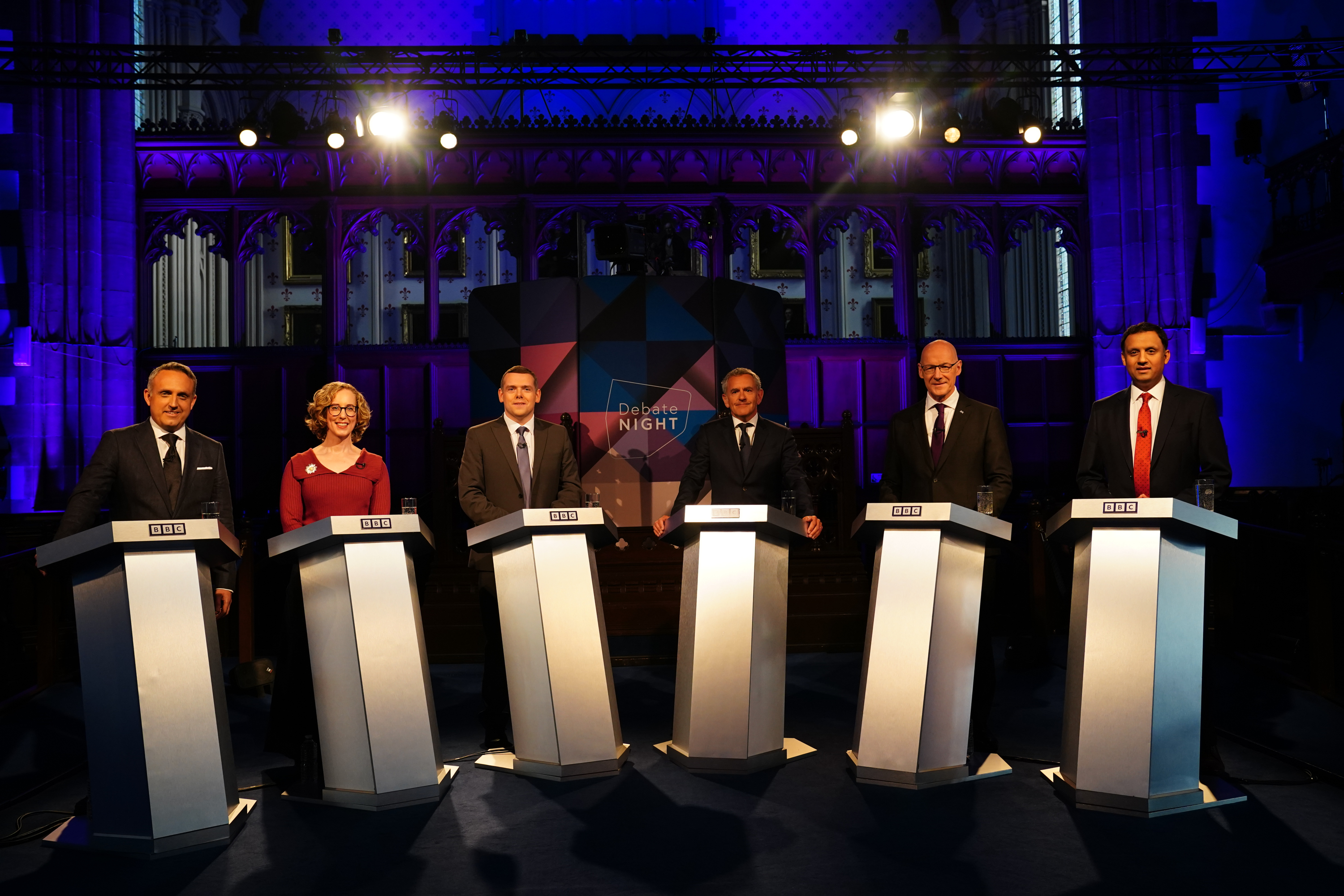 Scottish Liberal Democrat leader Alex Cole-Hamilton (left), Scottish Green Party co-leader Lorna Slater (second left), Scottish Conservative leader Douglas Ross (third from left), SNP leader John Swinney (second right) and Scottish Labour leader Anas Sarwar (right) with Debate Night host Stephen Jardine (third from right) moderating the live TV clash
