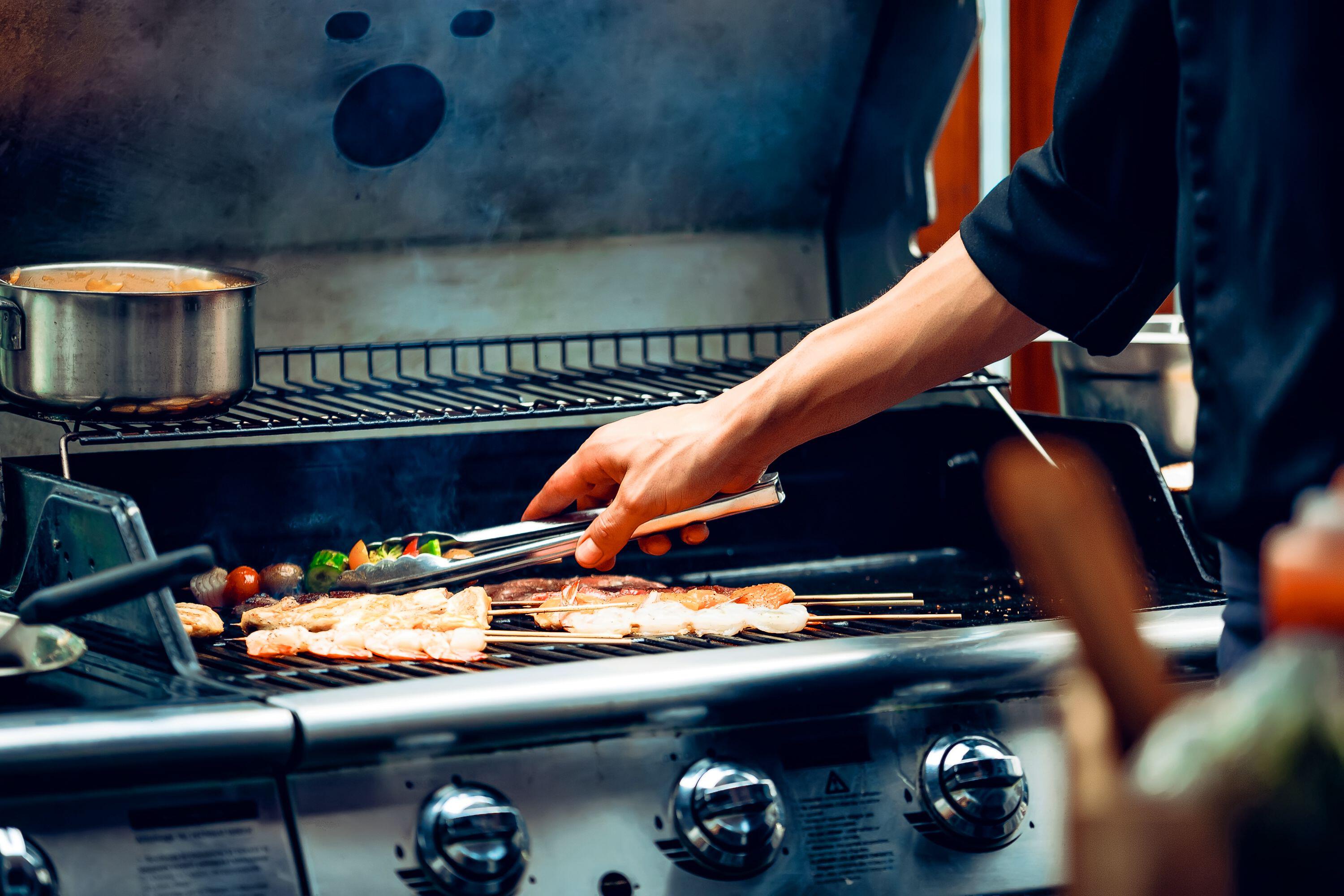 Chef cooking meat on a barbecue