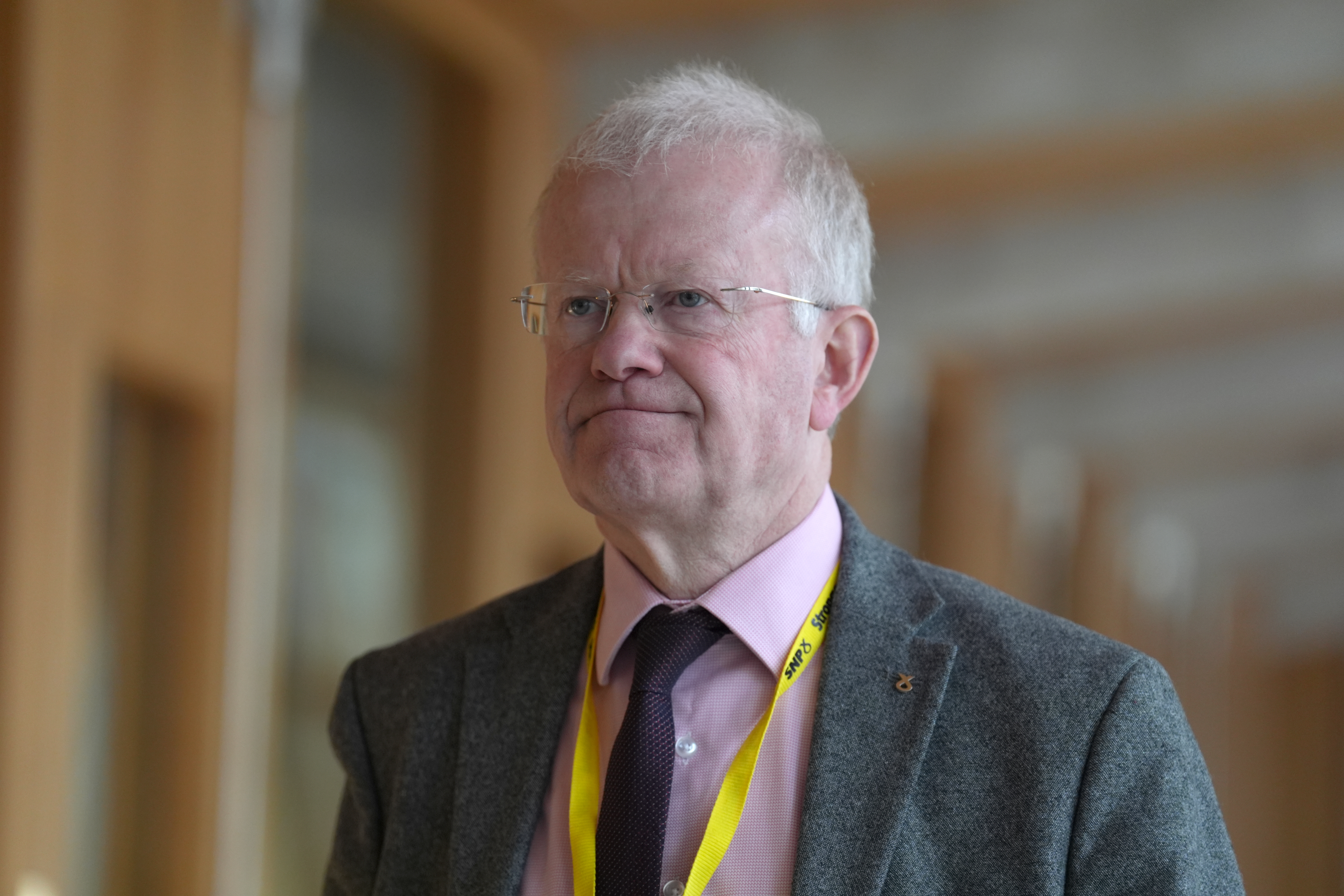 John Mason walking through a corridor at Holyrood