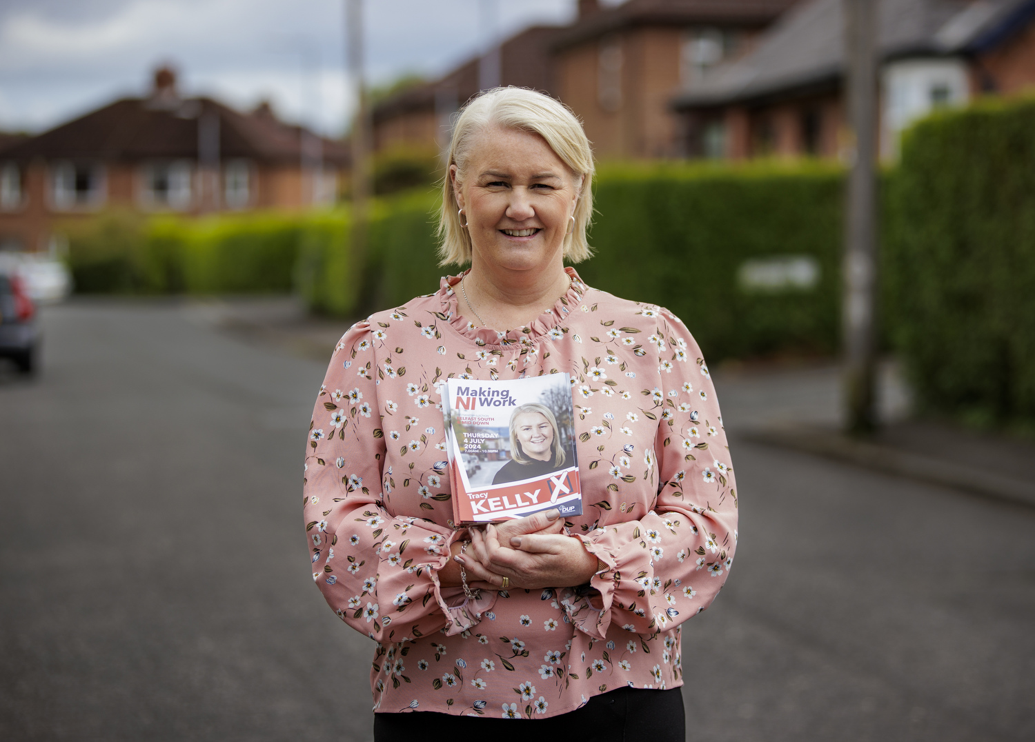 The DUP's Tracy Kelly standing in a street holding her own campaign literature