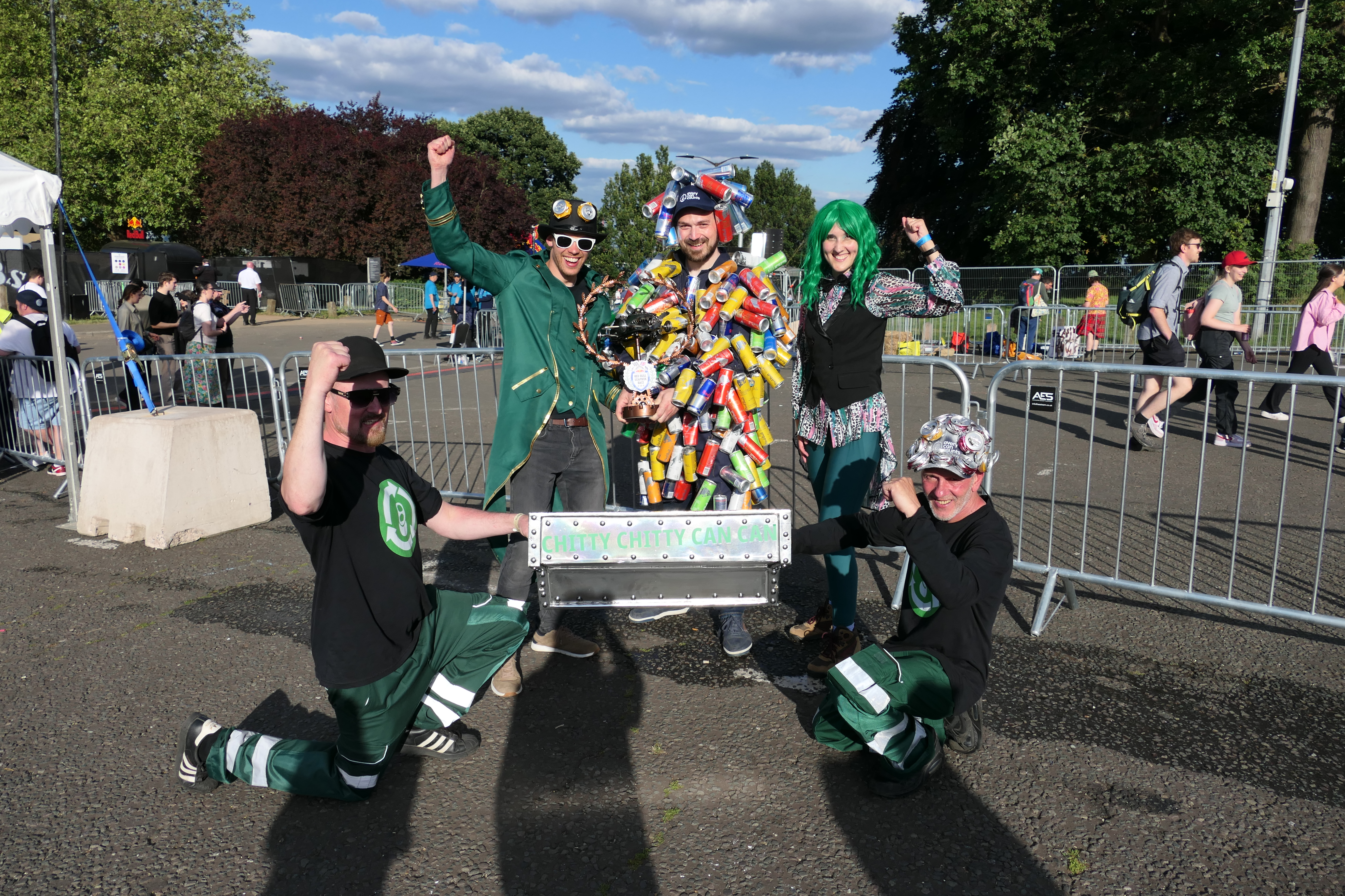 Every Can Counts soapbox team holding their trophy, including a man dressed in an outfit made out of drinks cans