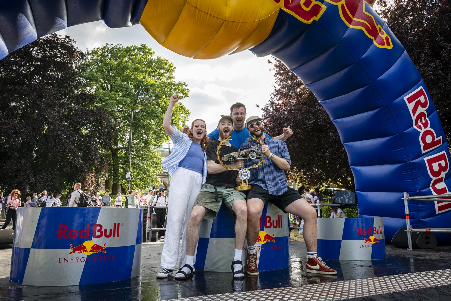 The Hurry Houdinis celebrate with their trophy on a podium emblazoned with Red Bull logos