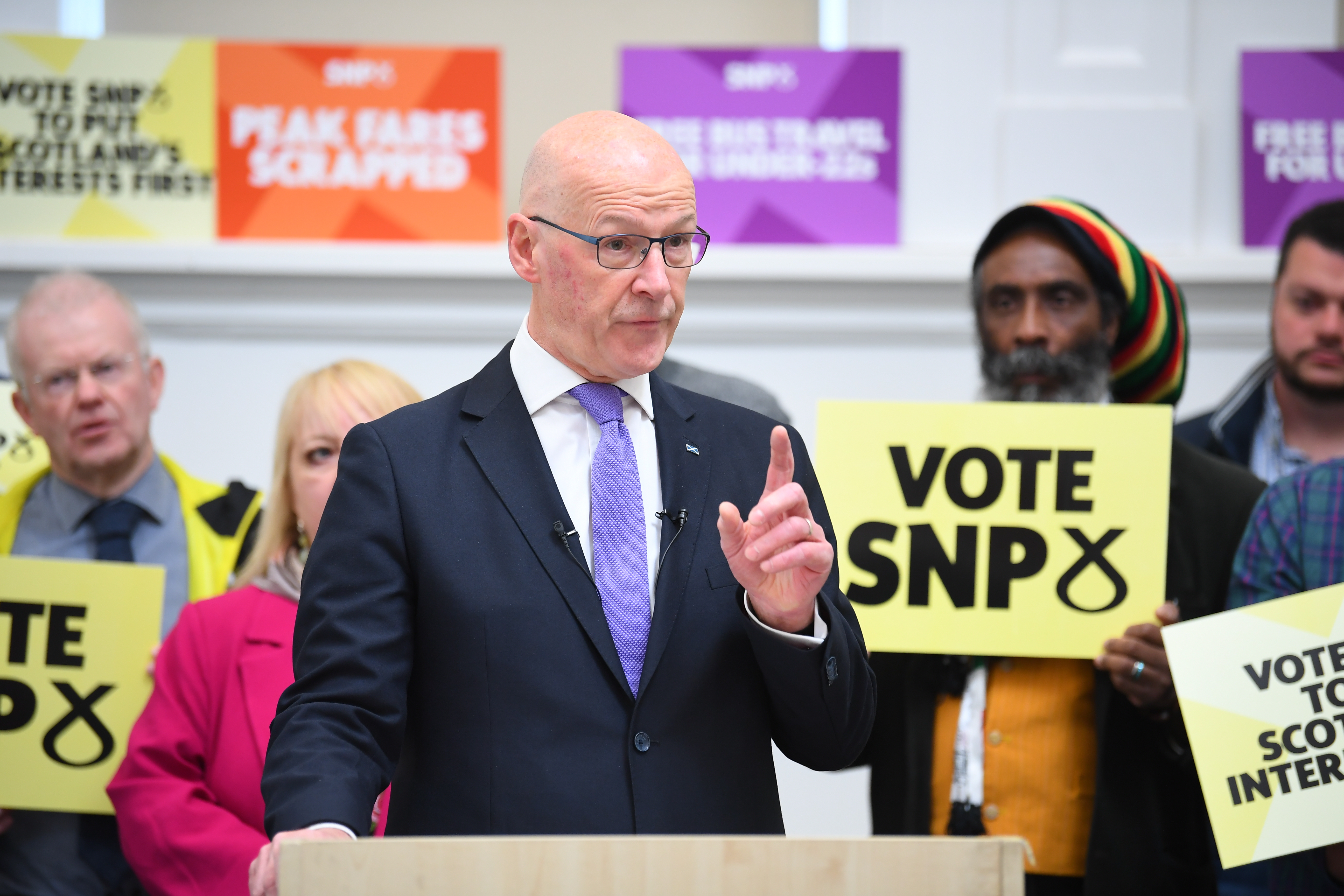 John Swinney makes a speech with SNP activists in the background