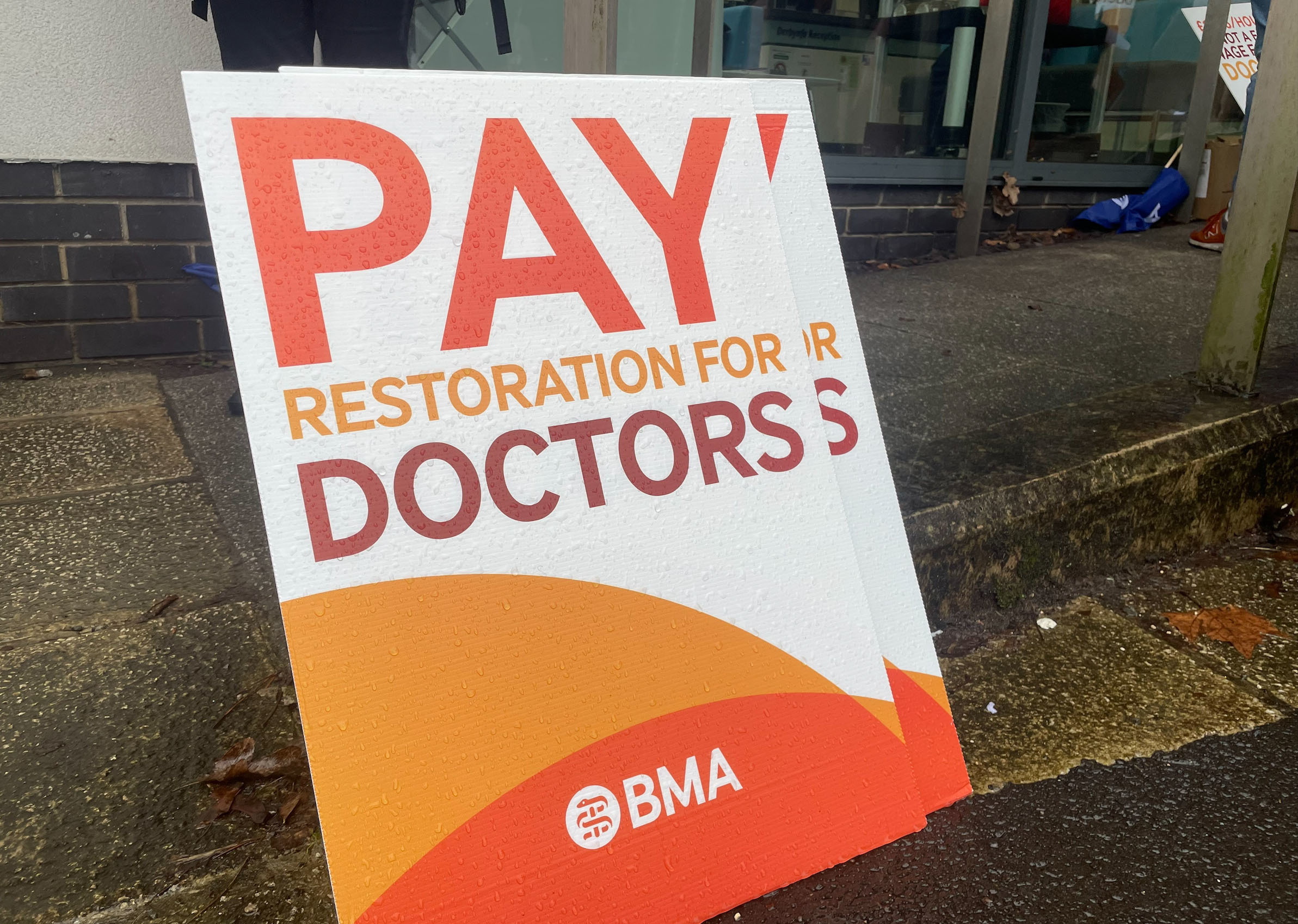 A BMA placard reading 'Pay restoration for doctors'