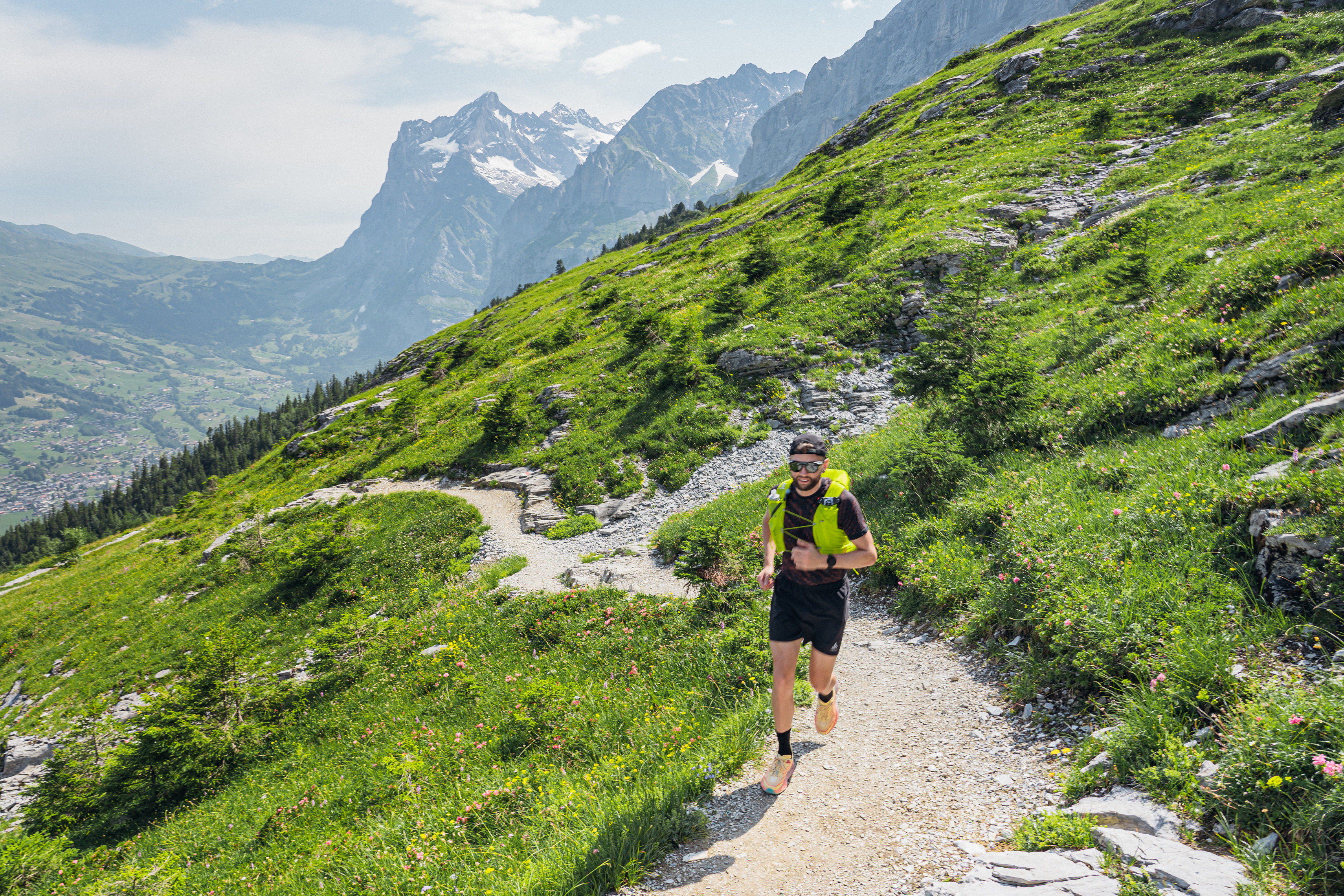 Jake Catterall running along a path along the side of a mountain in Switzerland