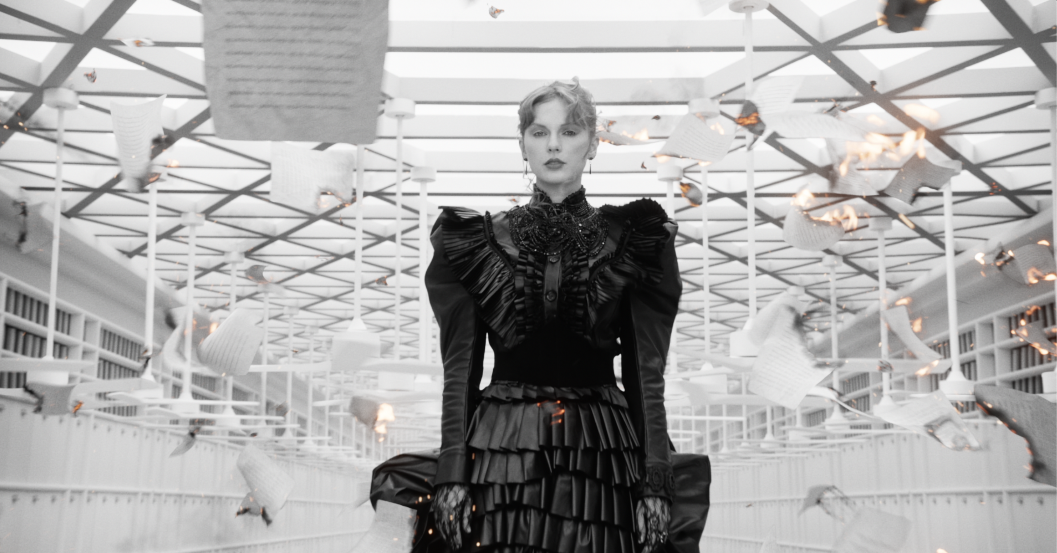 A still of Taylor Swift wearing a black ruffled gown in her music video