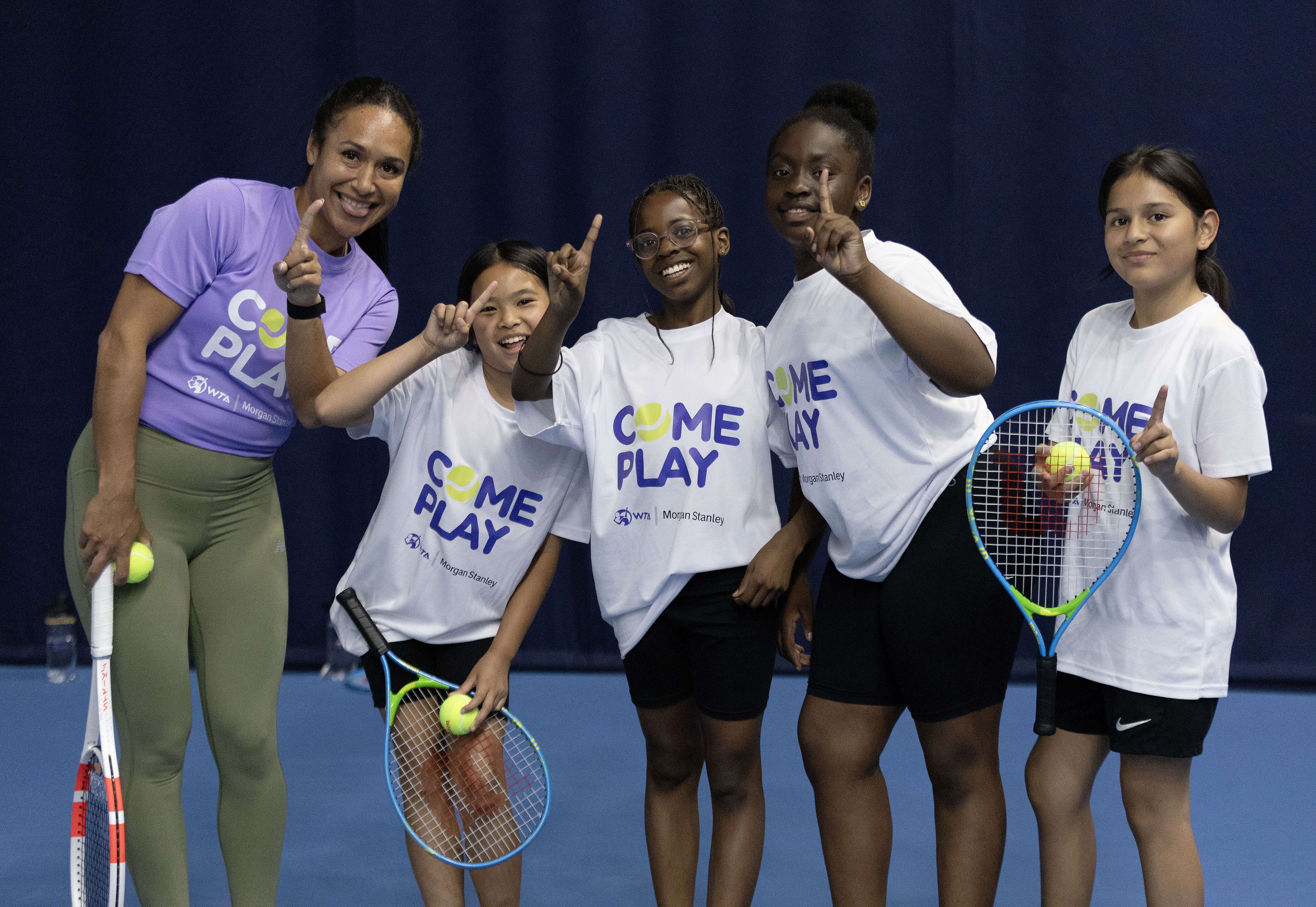 Heather Watson, left, poses with children from Elena Baltacha's Foundation during a Come Play presented by Morgan Stanley day in London
