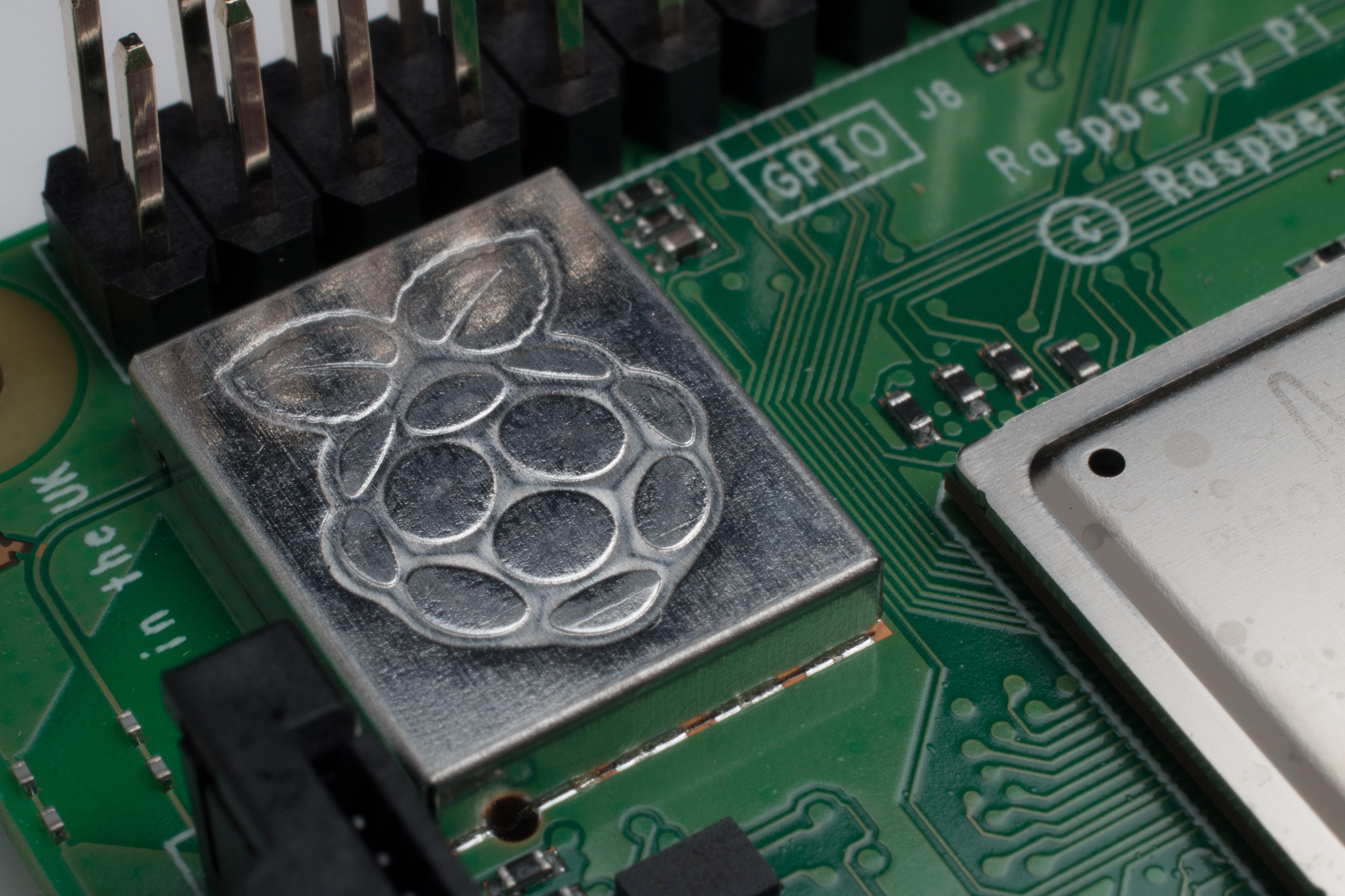 Close-up of the Raspberry Pi logo etched on a circuit board