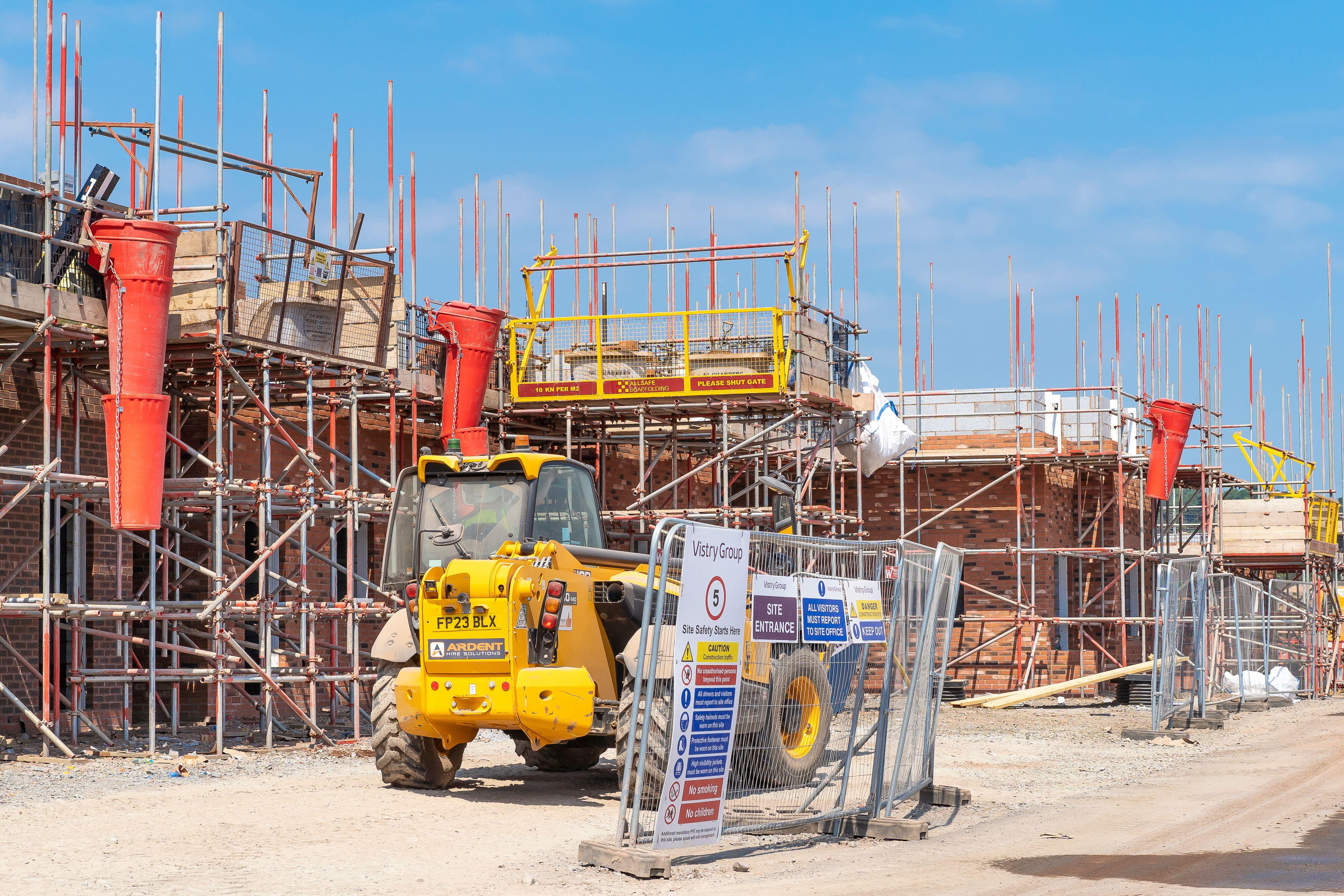 Newbuild homes under construction surrounded by scaffolding